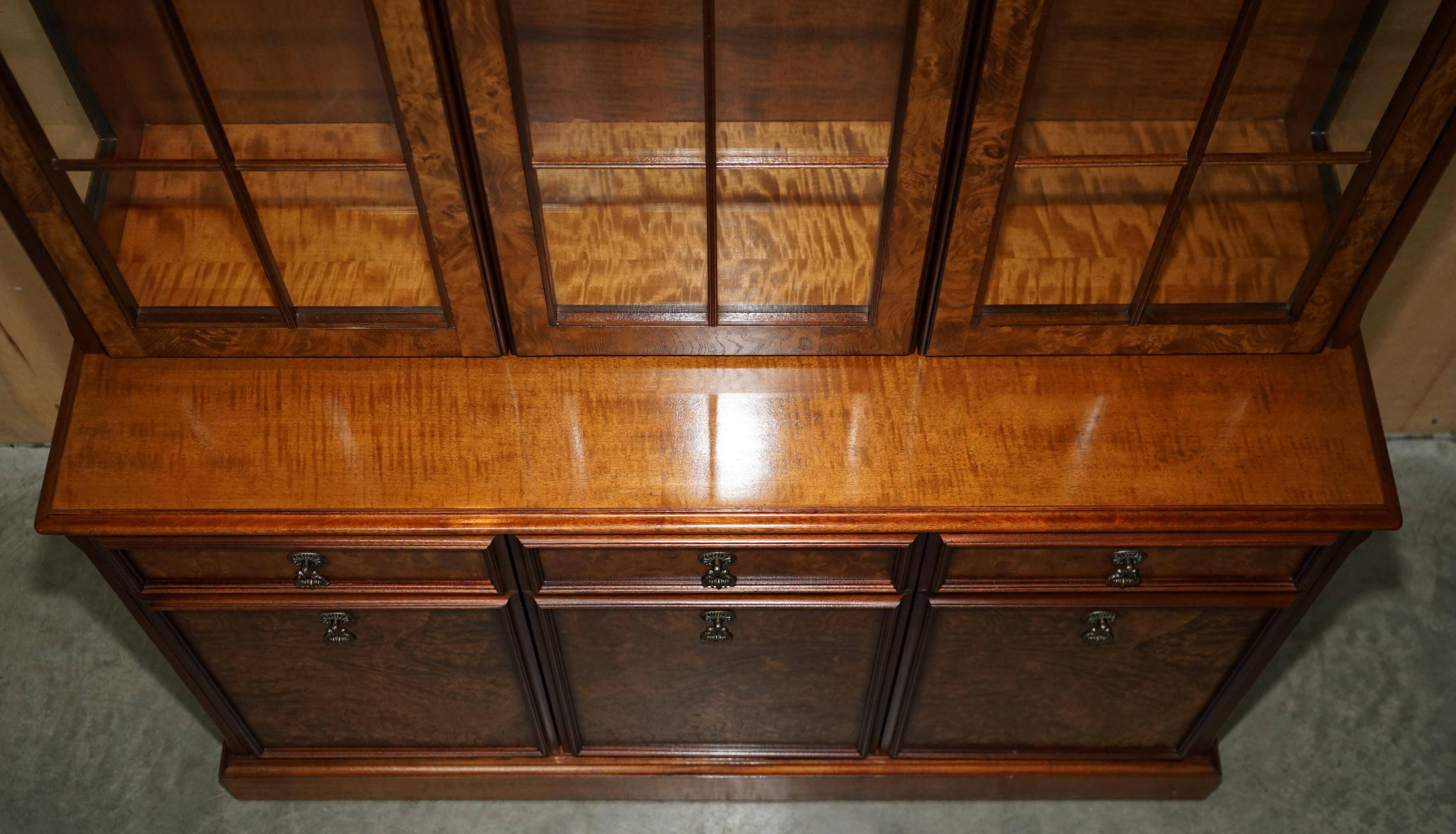 Vintage walnut burr buffet with glass and lighting, Art Deco style.