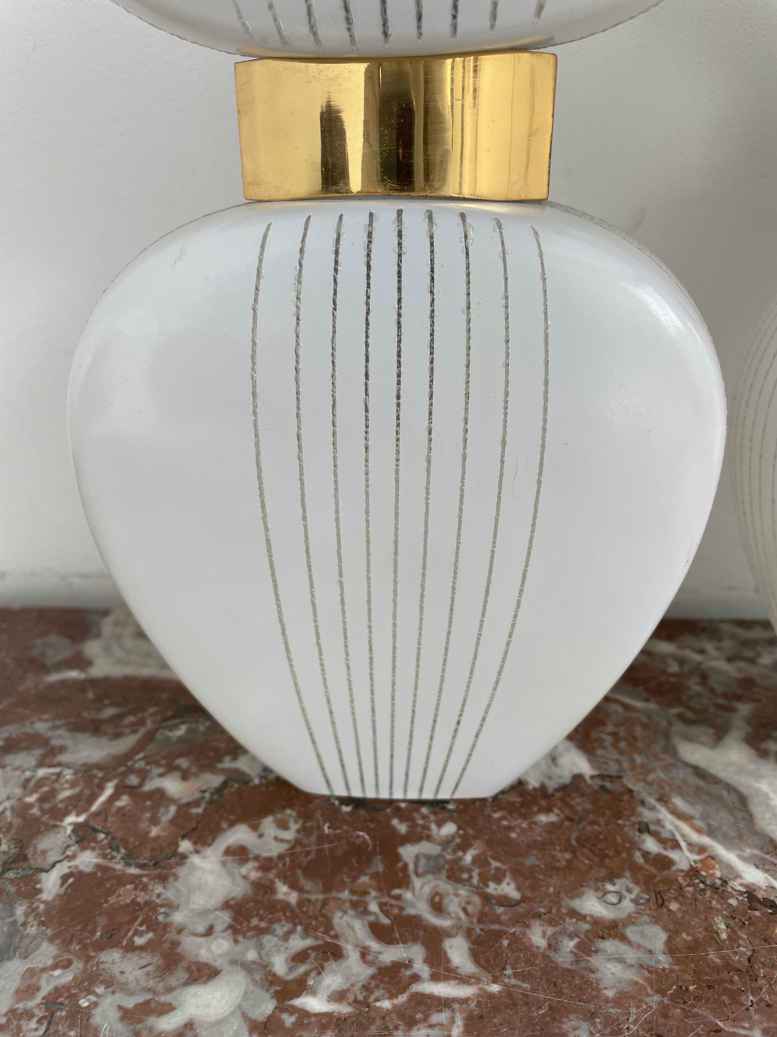 Pair of vintage wall lights from the 60s-70s in striped opaline glass and gilded brass.