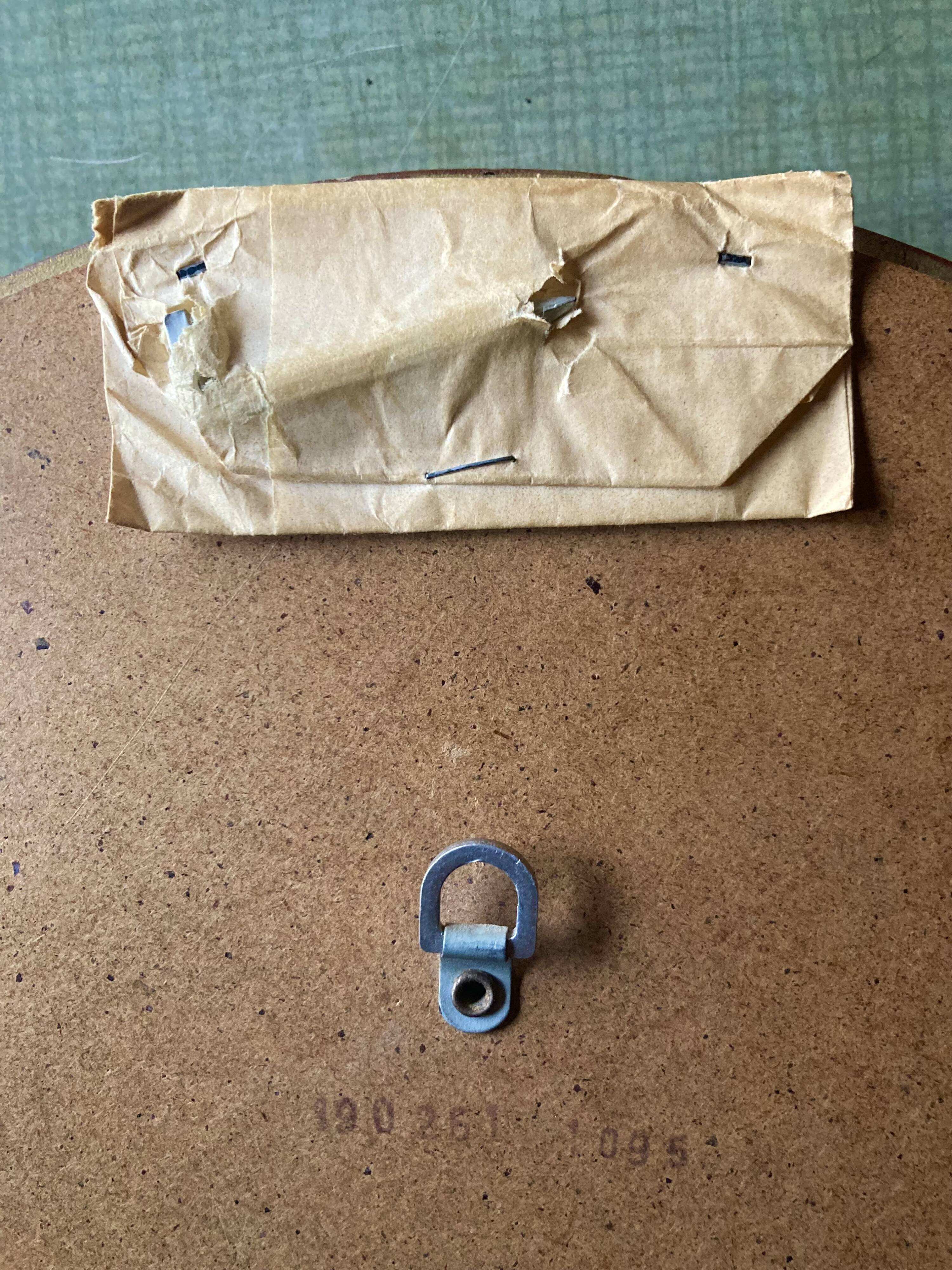 Old large oval wall mirror in golden resin