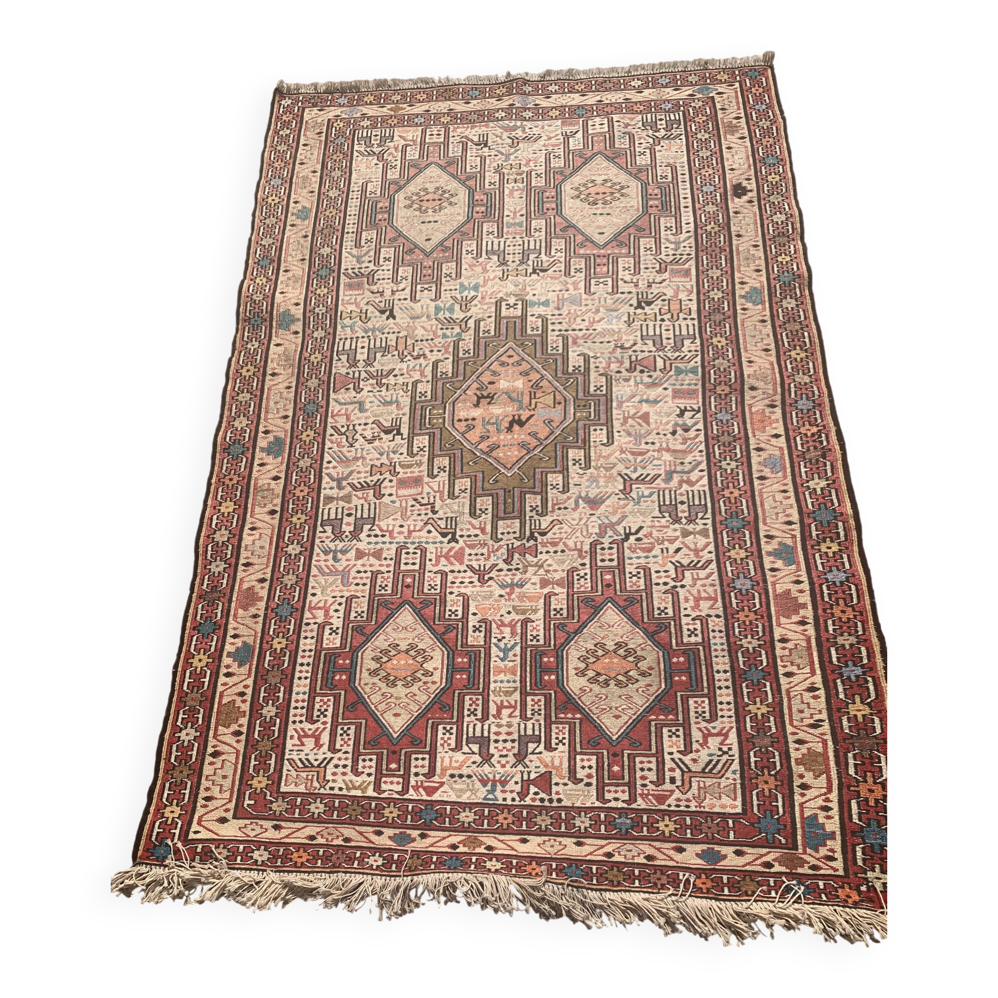 Hand-knotted silk carpet purchased in Iran – geometric and animal design –