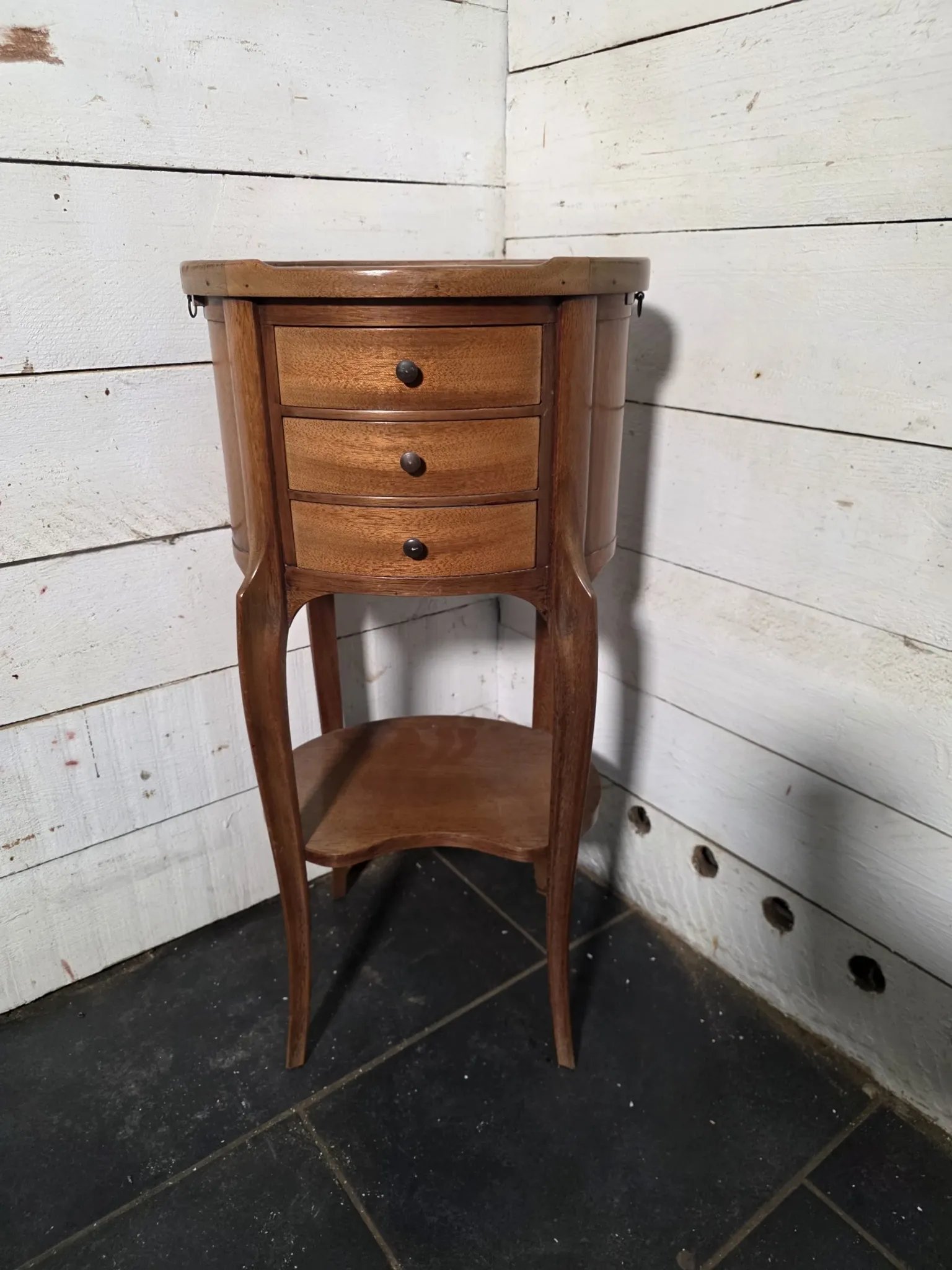 Oval bedside table in Louis XV style made of mahogany.