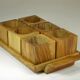 Six egg cups on a wooden tray.