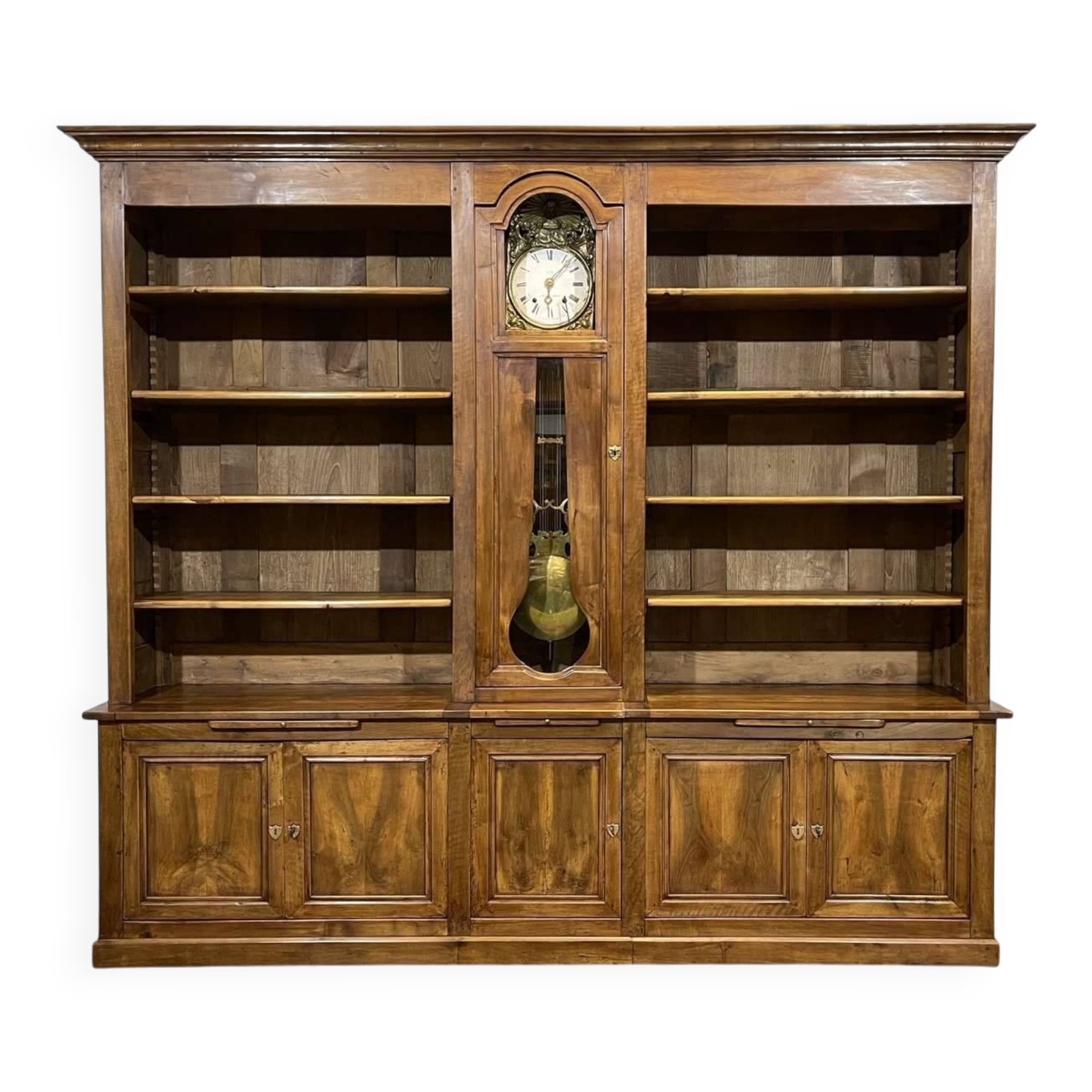 Library in walnut and oak from the early 20th century with its central clock.