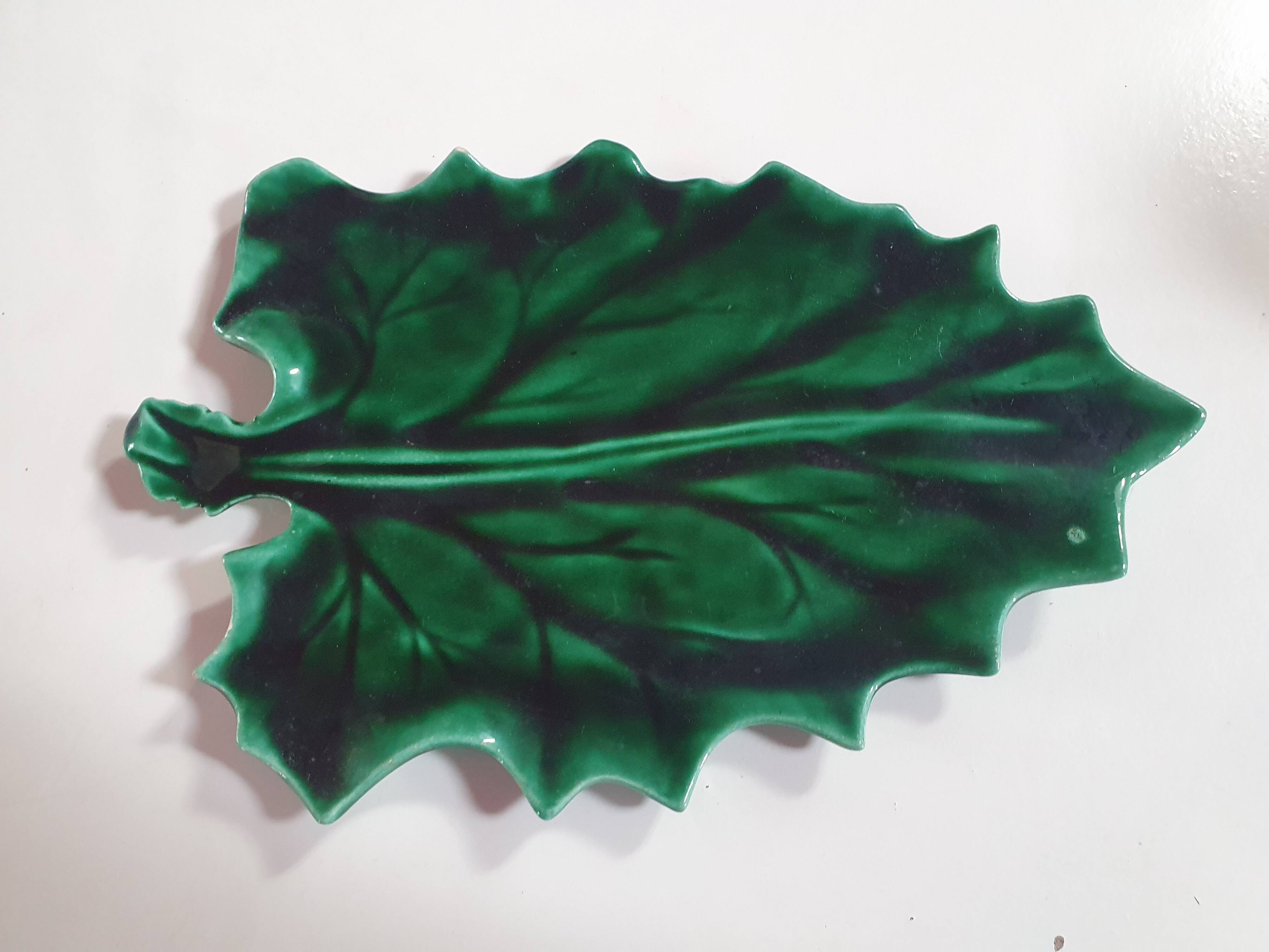 empty green ceramic pocket cup, small chips on the edges, signed