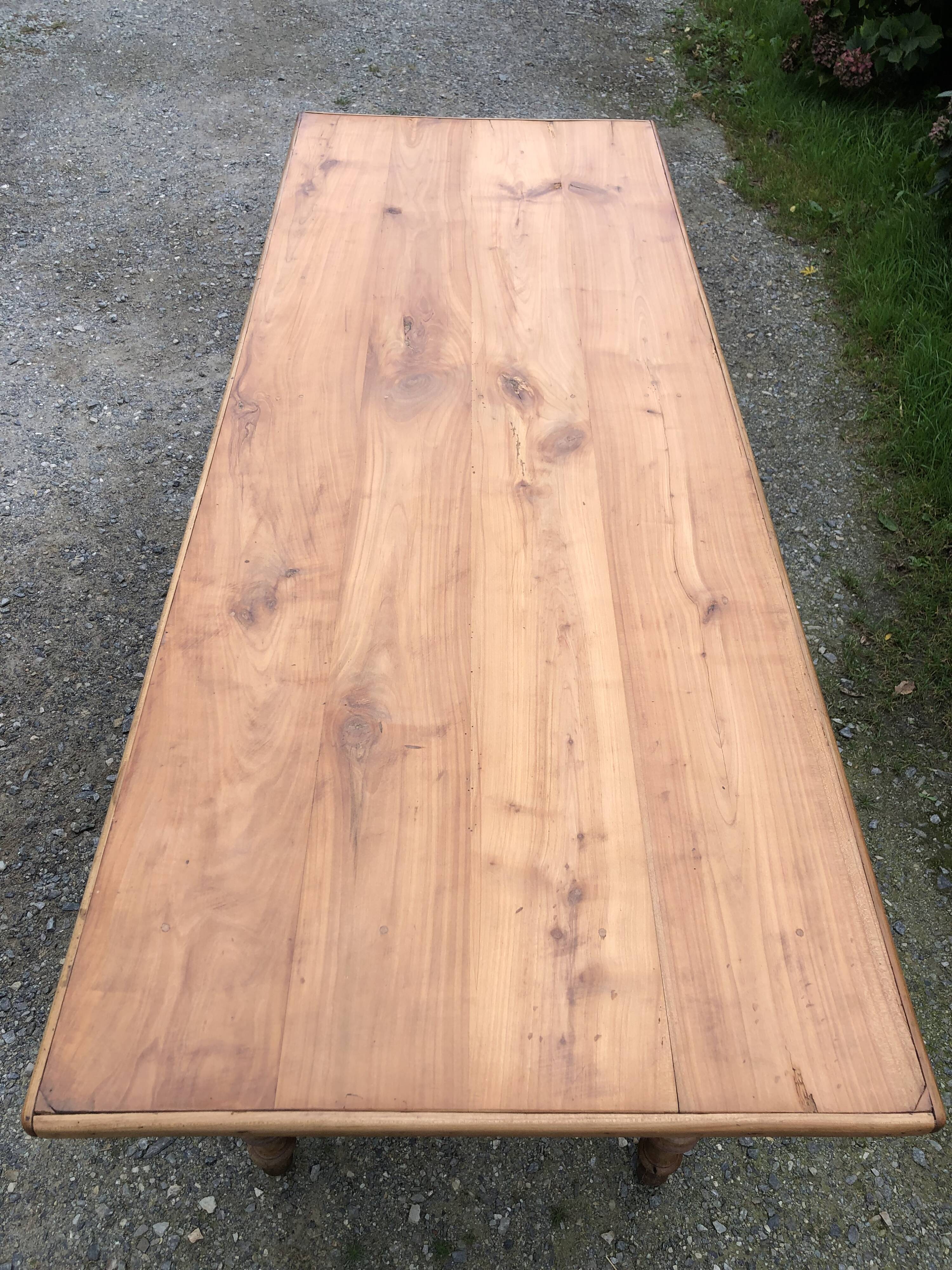Antique Louis Philippe style farm table in solid cherry wood with 2 drawers and turned base.