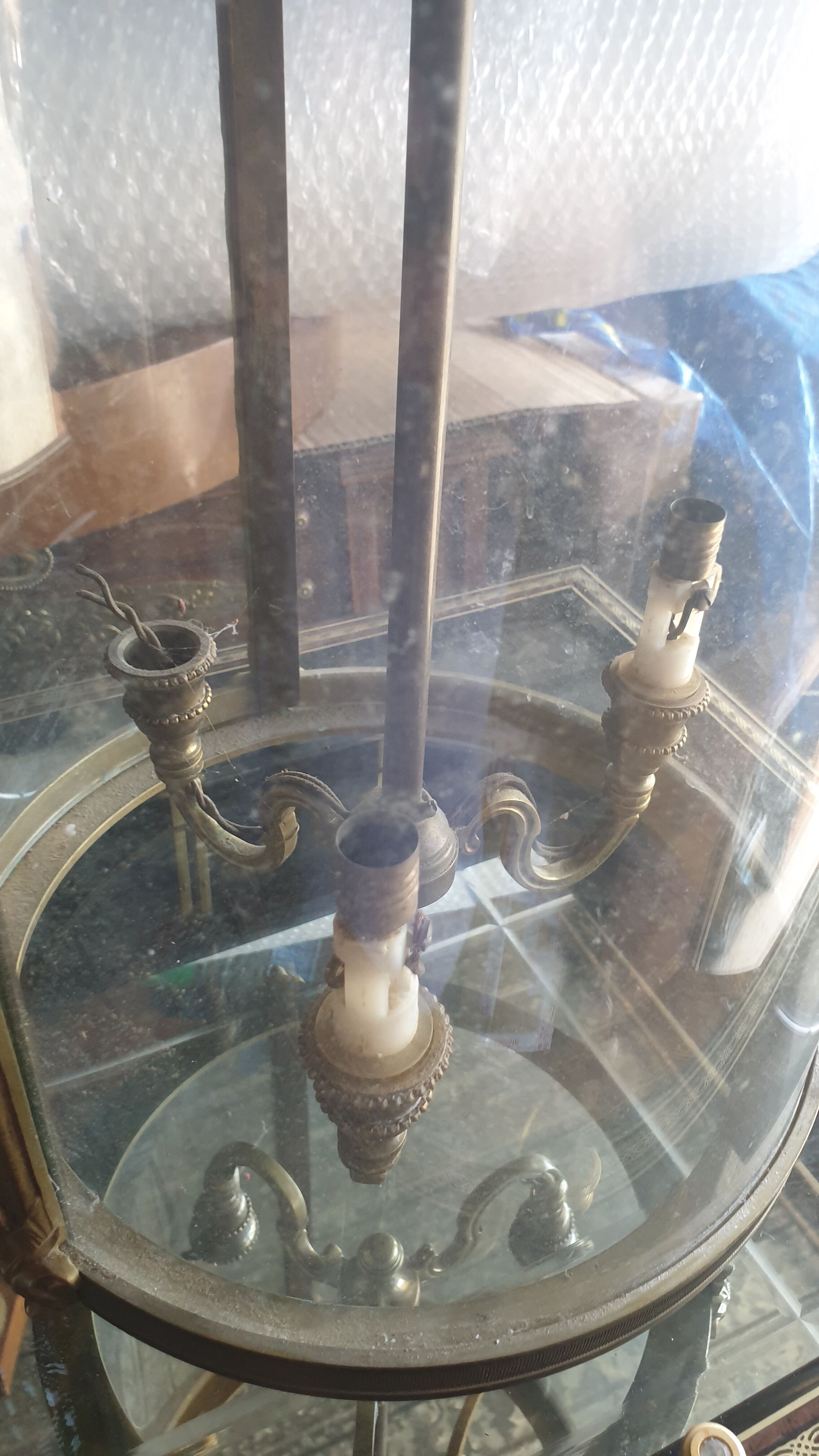 Suspension in glass and brass