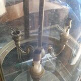 Suspension in glass and brass