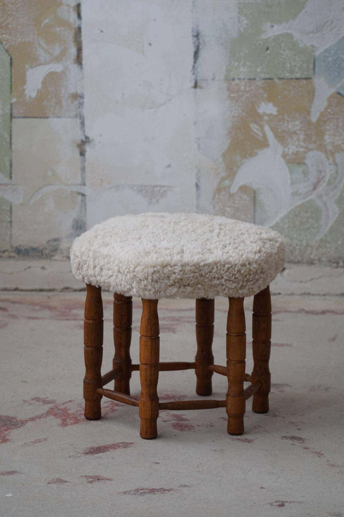 Modern Danish, a hexagonal oak stool, seat reupholstered in lambswool, 1950s.