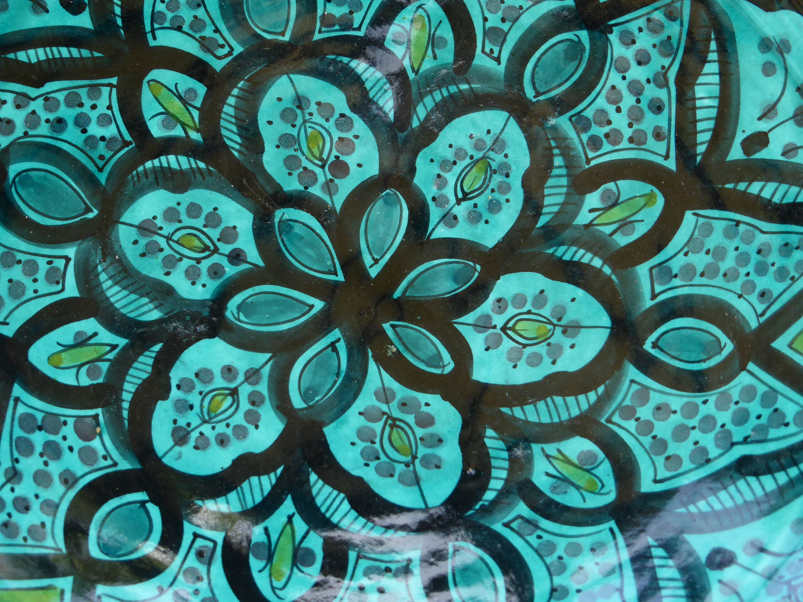 Hand-painted vintage oriental hollow dish, black patterns on a turquoise background