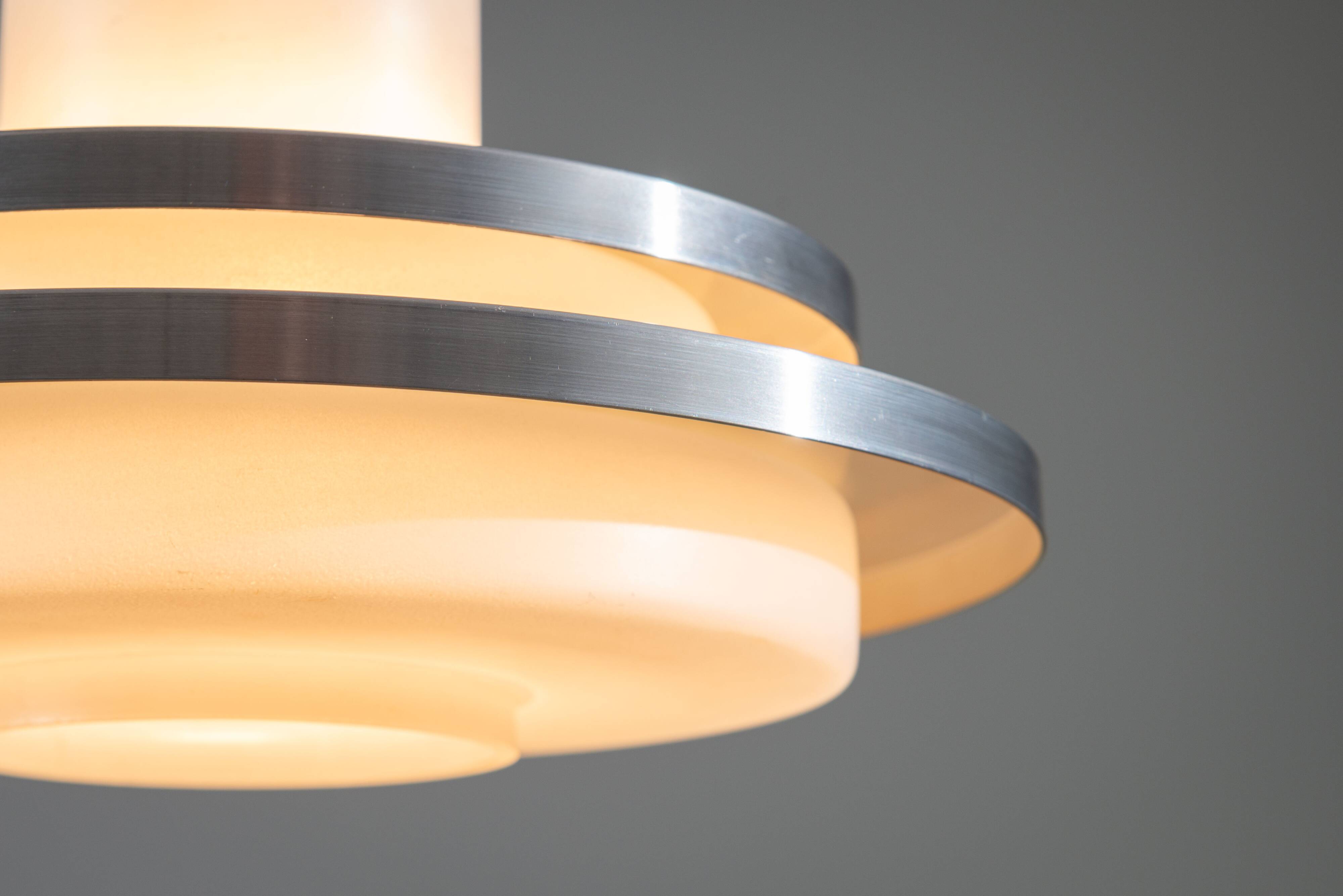 Doria pendant in opal glass with decorative aluminium discs