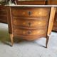 Curved chest of drawers in rosewood and marble marquetry