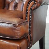Very beautiful, stately, cowhide Chesterfield wing chair with elegant legs in a nice brown color