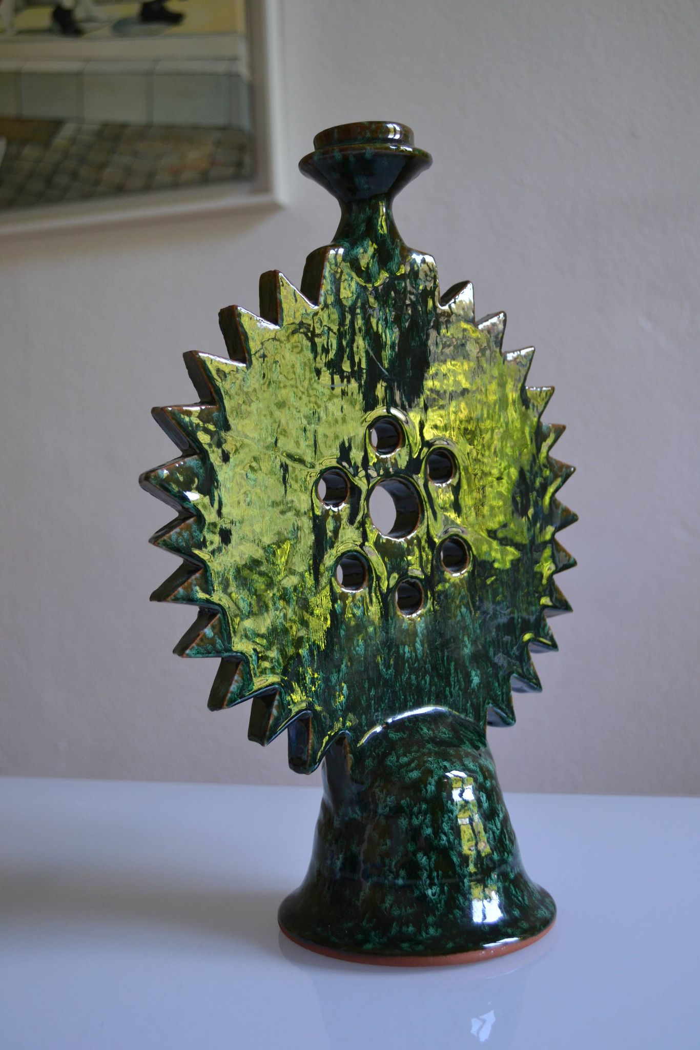 Green ceramic sun candlestick from Tamegroute, Morocco.