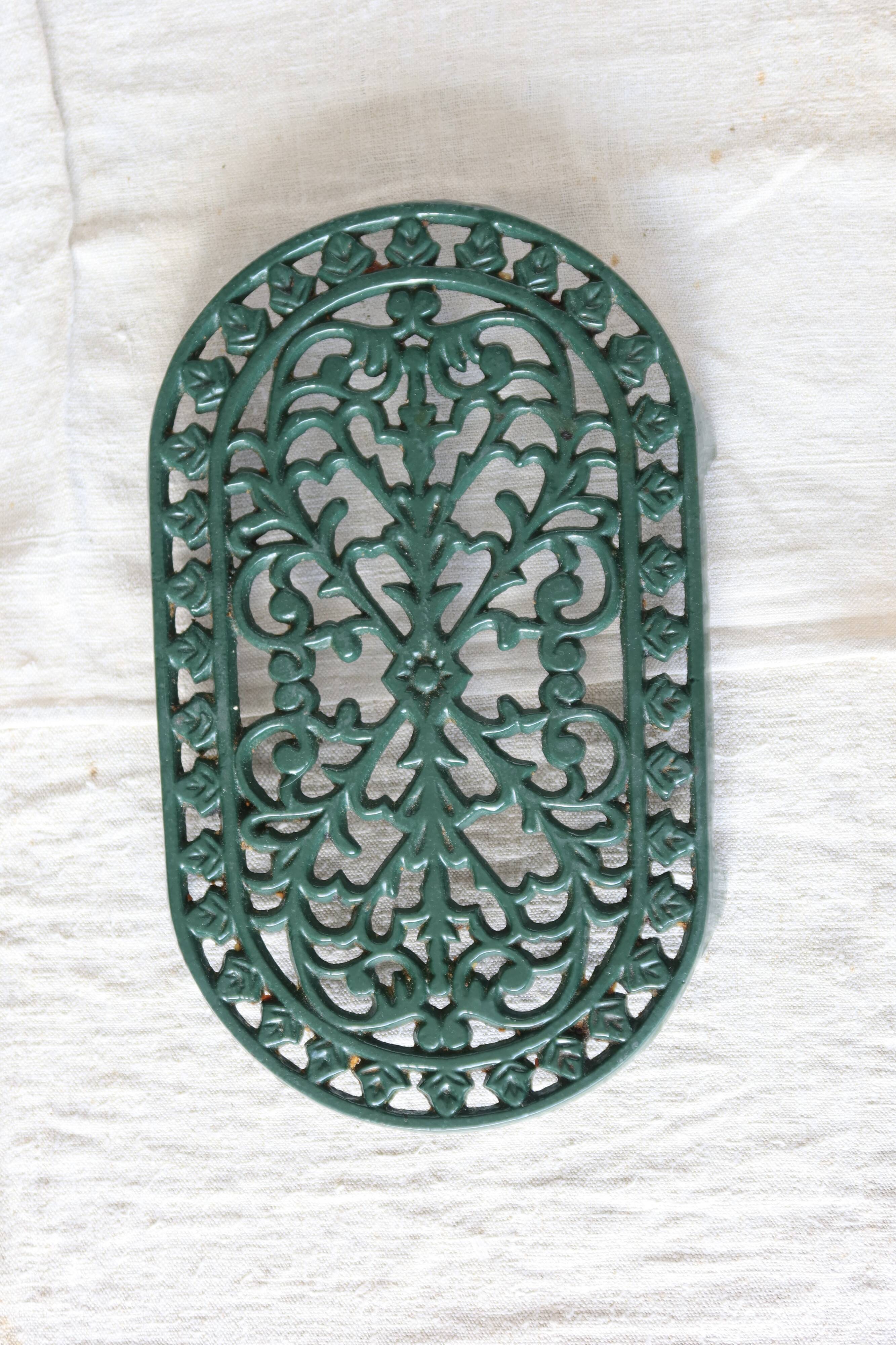 Vintage dark green cast iron oval trivet - Openwork design