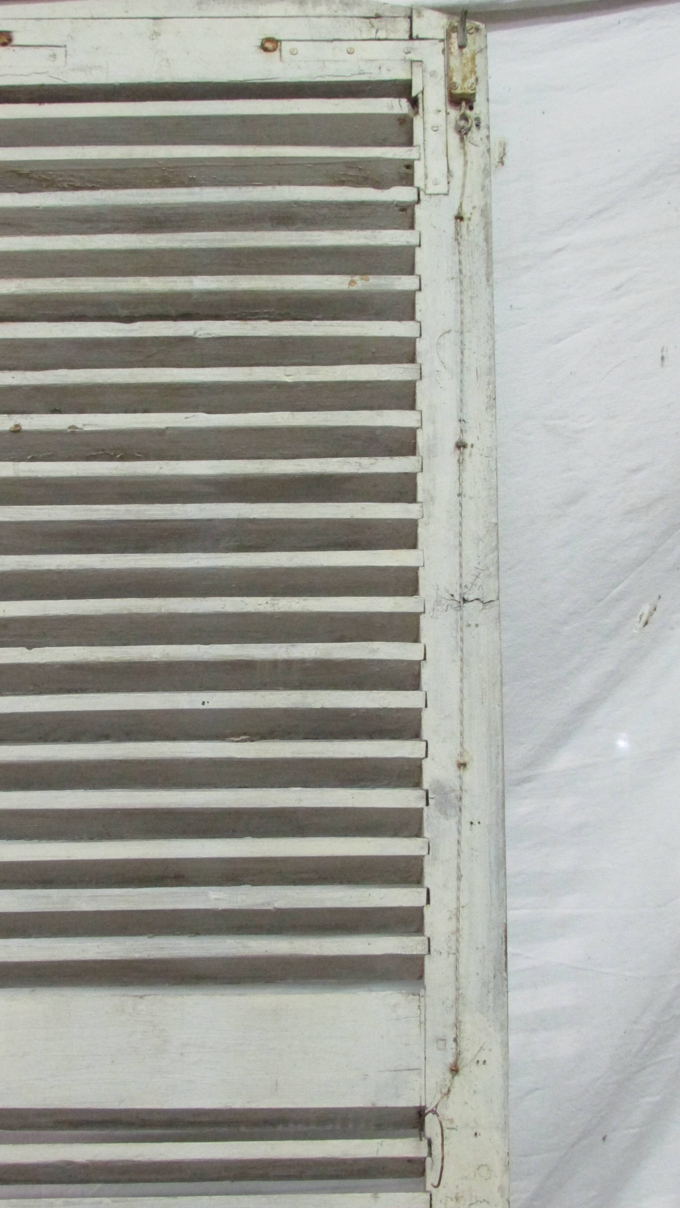 Old wooden shutter with perforations.