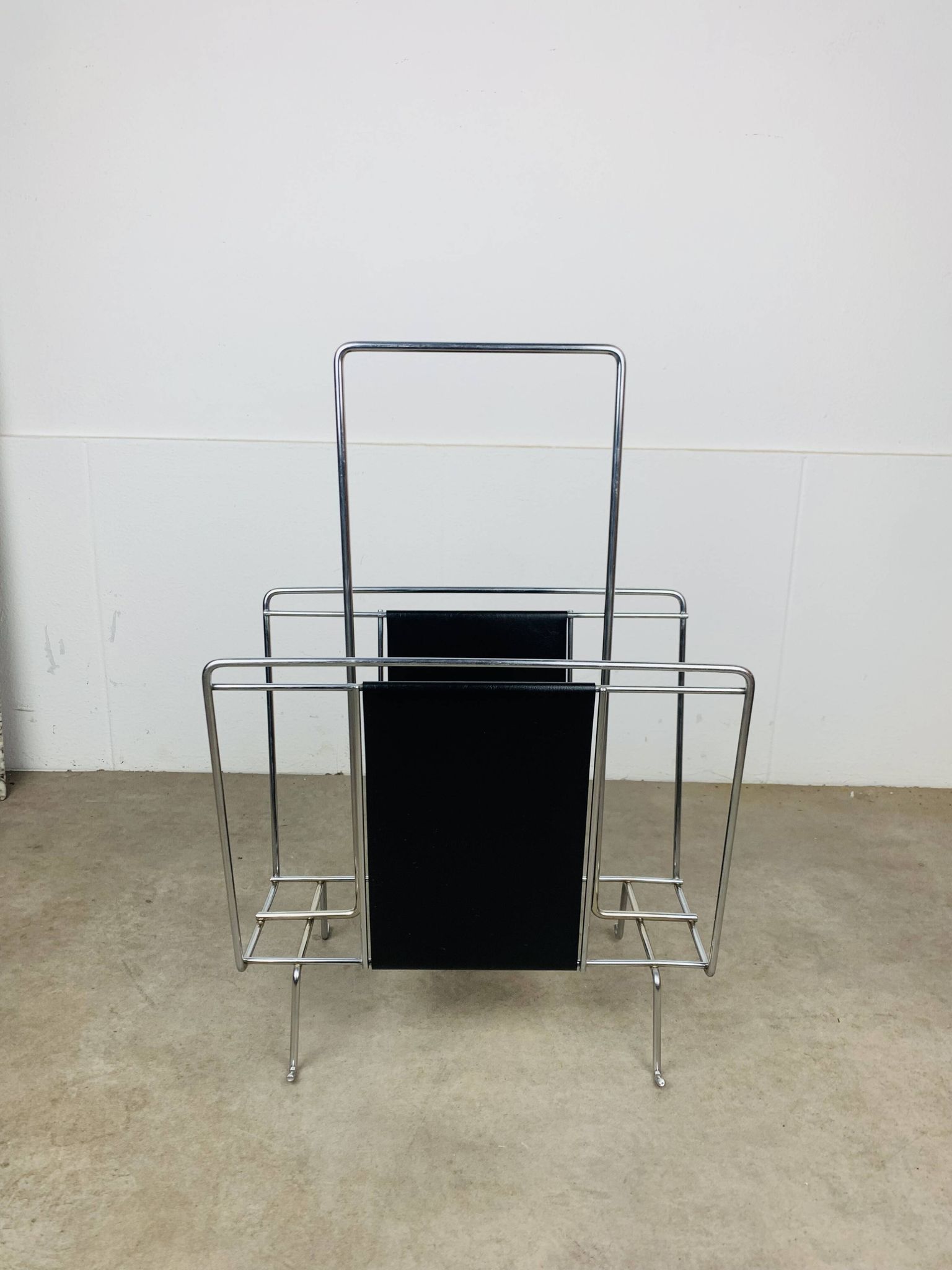 Chrome and black leather magazine rack, 1970s.