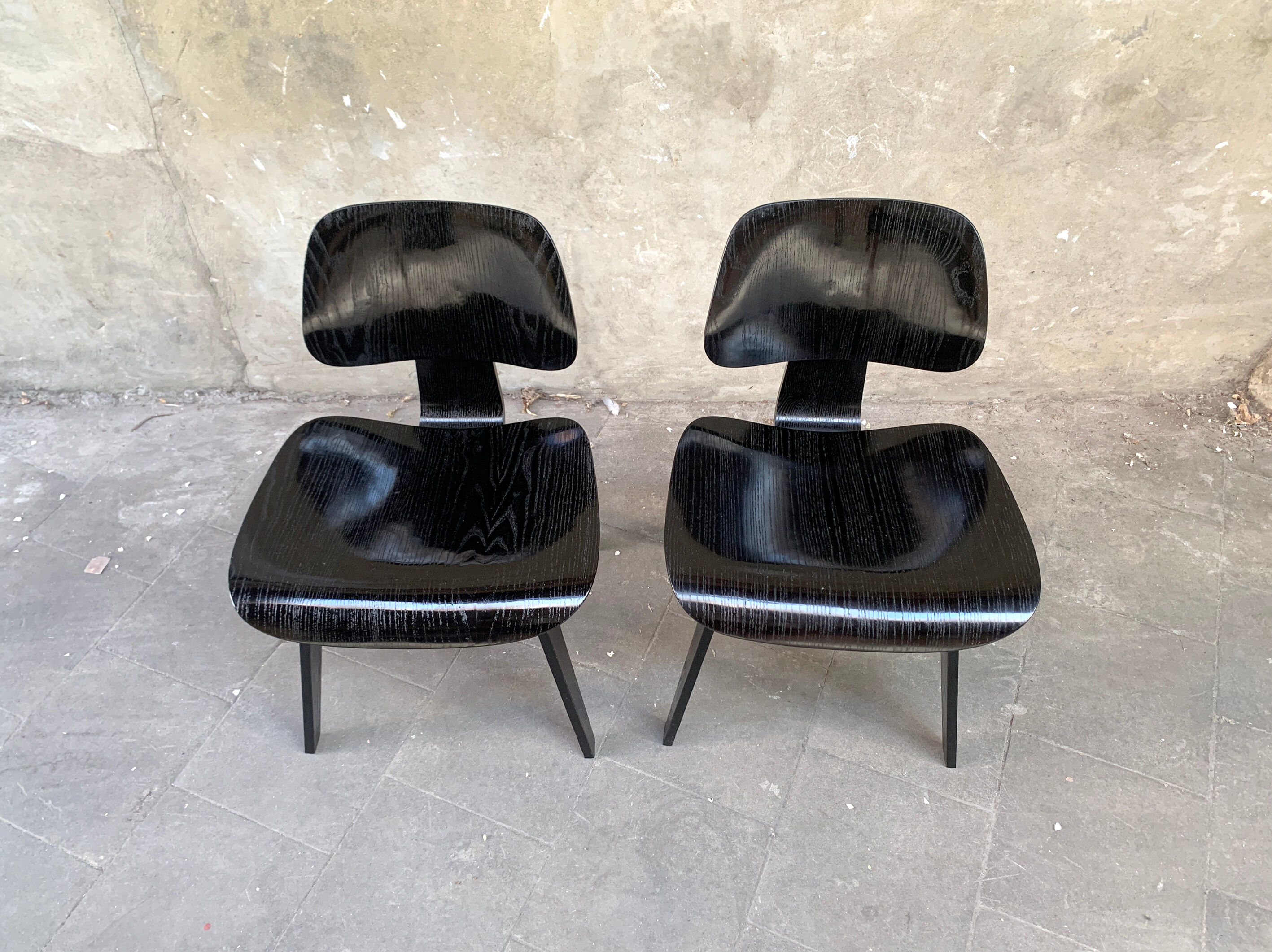 Pair of DCW chairs by Charles & Ray Eames in Black for Herman Miller 1950