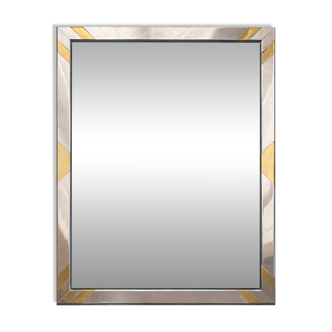 Faceted modernist wall mirror in steel and brass, geometric mixed metal frame 1970s.