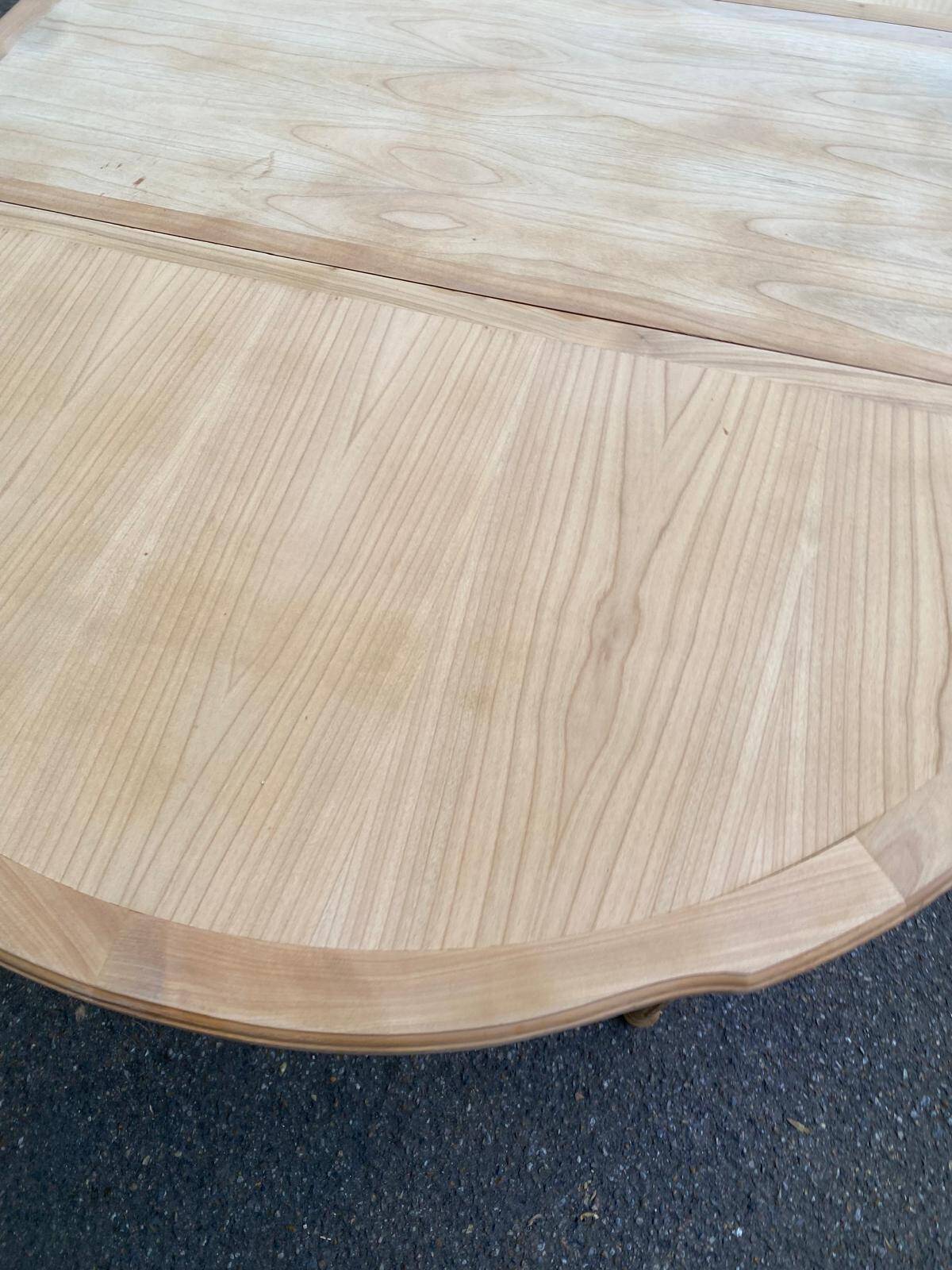Extendable round table in renovated Louis XVI style, made of light wood, with 2 extensions.