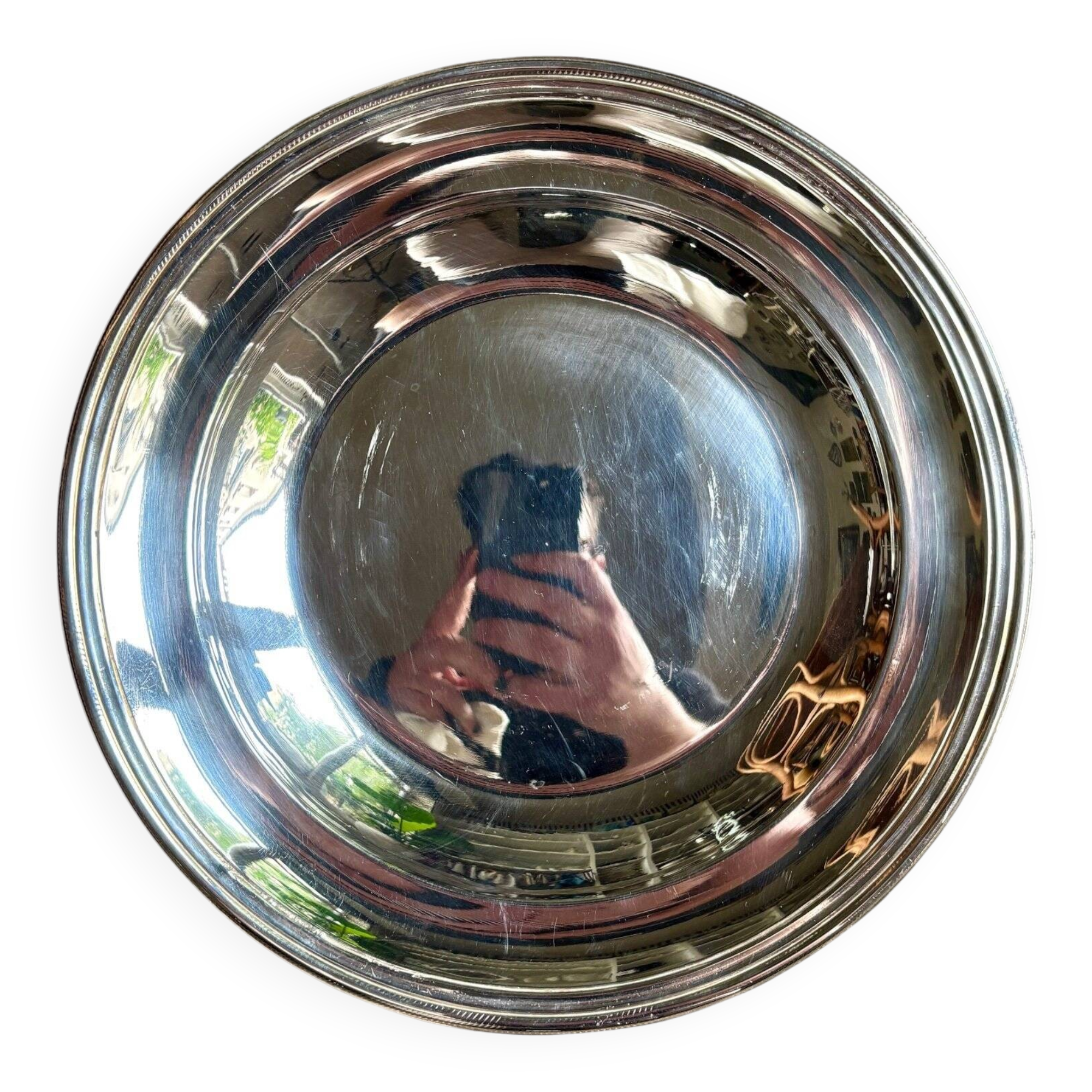 Round, hollow silver-plated metal dish