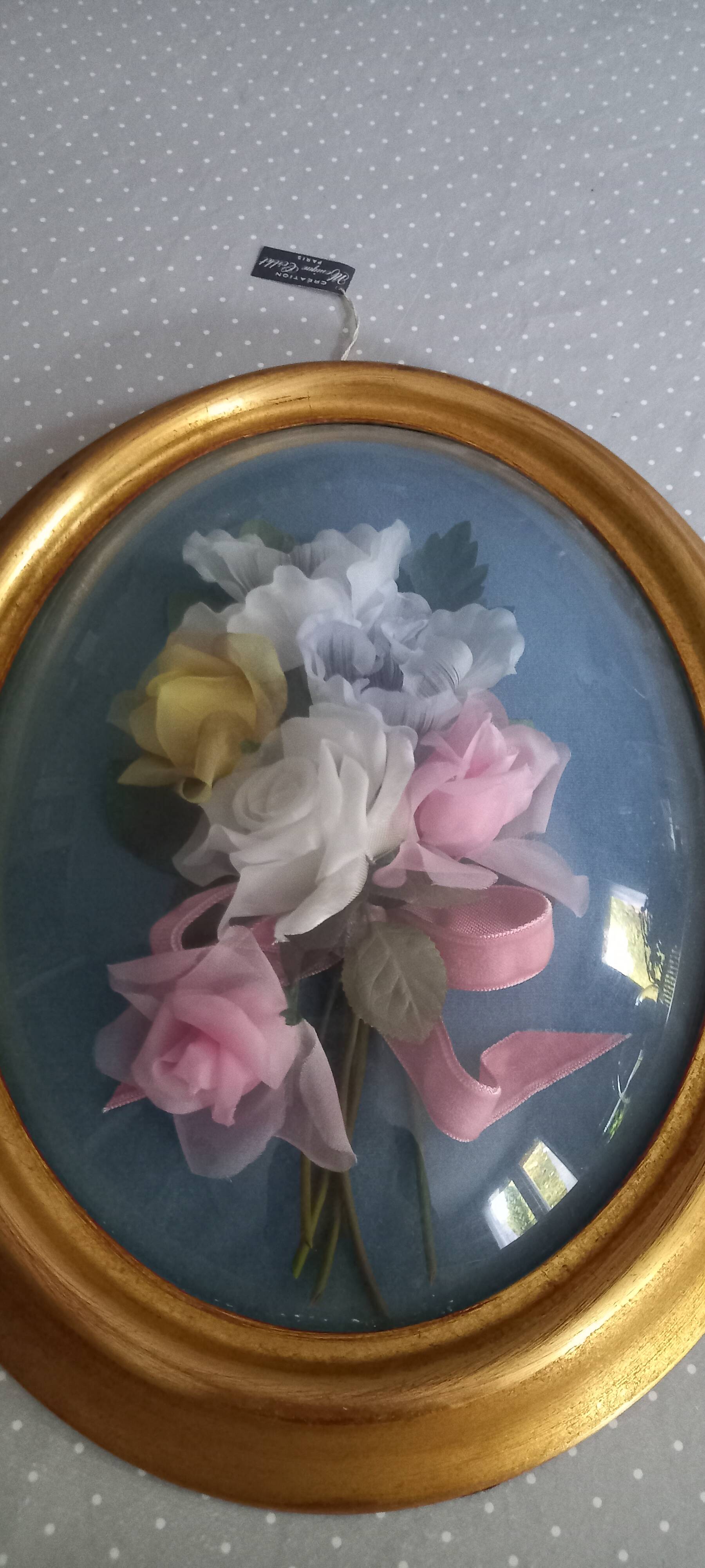 Silk flower frame under curved glass
