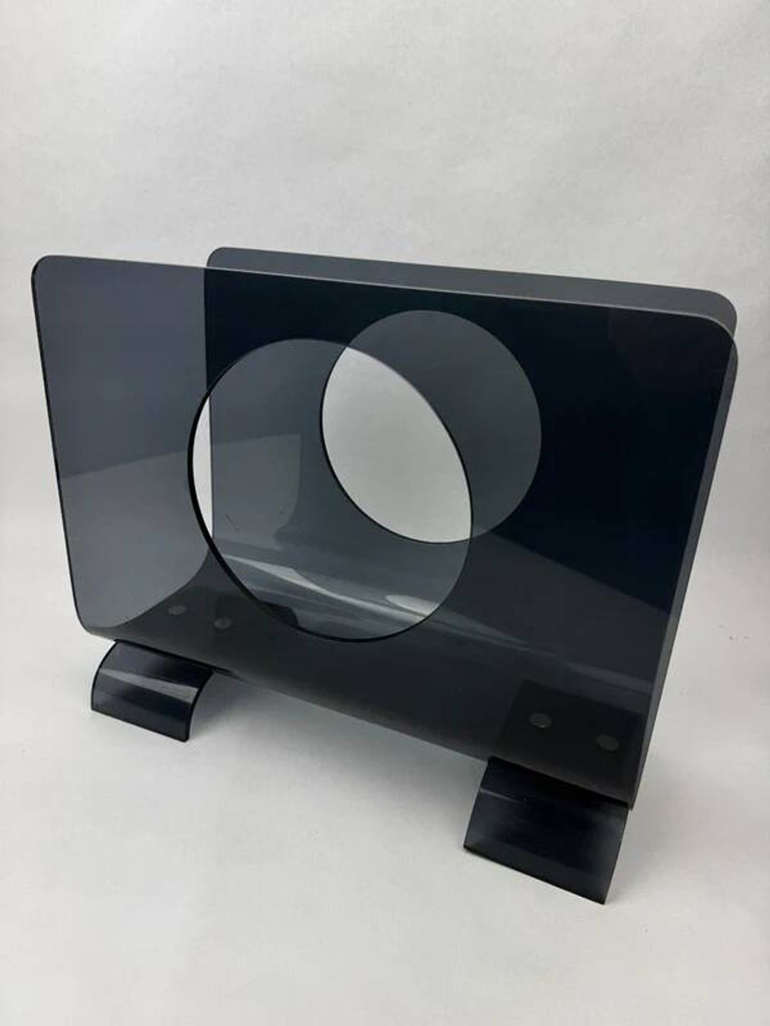 Vintage 1970s smoked plexiglass magazine rack, minimalist design.