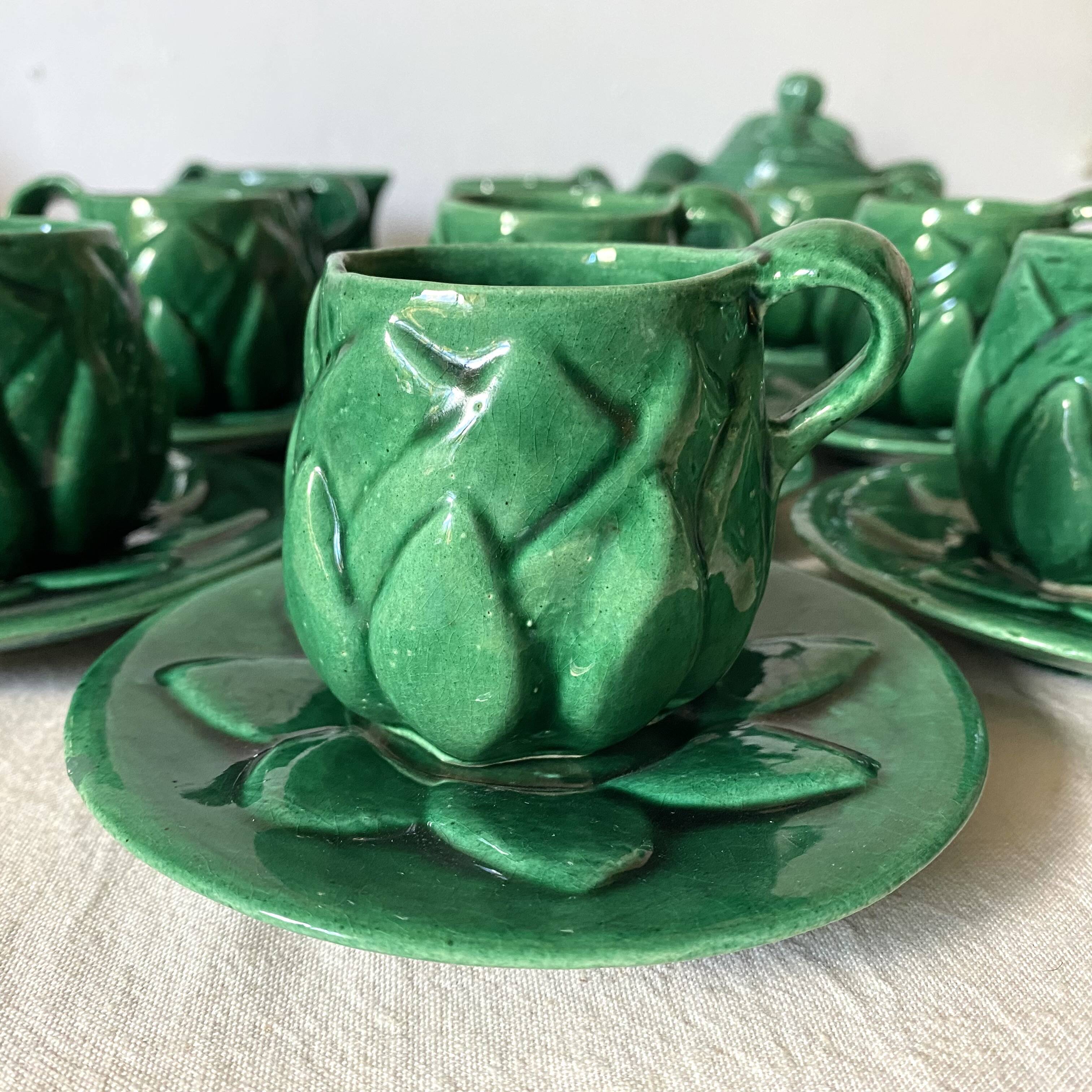 Antique slip cups with saucers, sugar bowl and milk pitcher