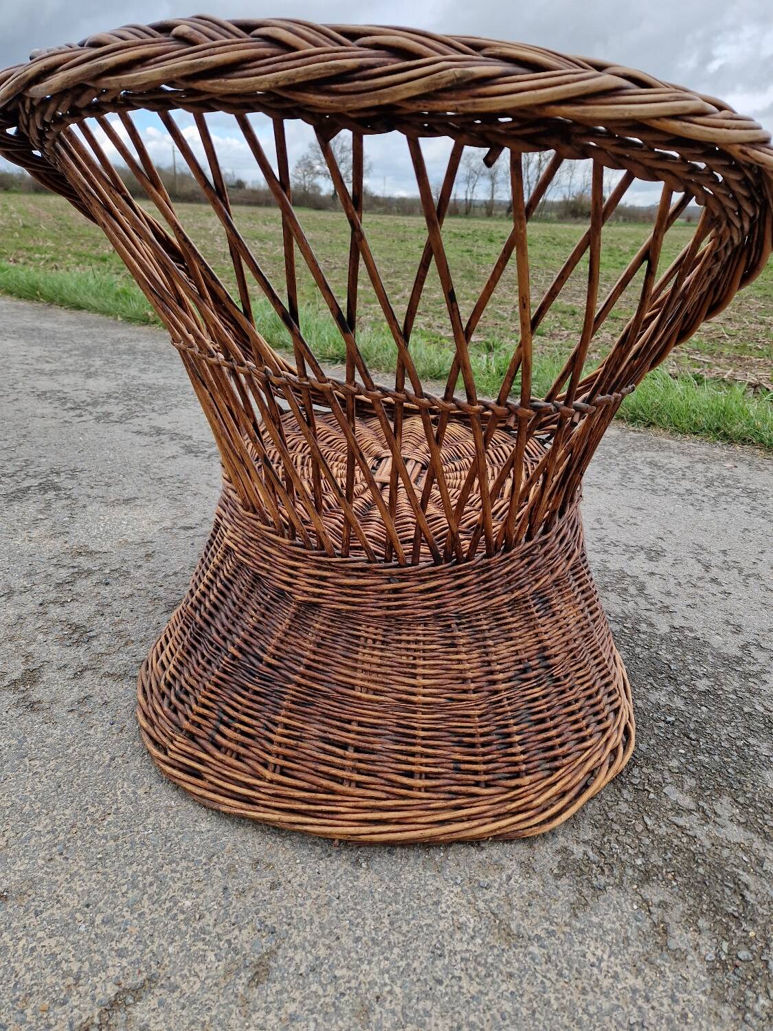 Old throne basket armchair in woven wicker