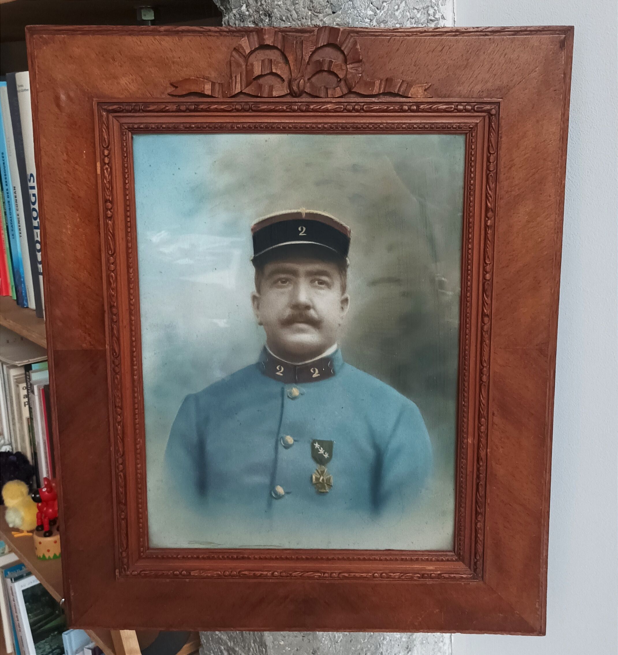 Antique wooden frame with carved portrait knot