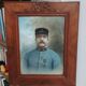 Antique wooden frame with carved portrait knot