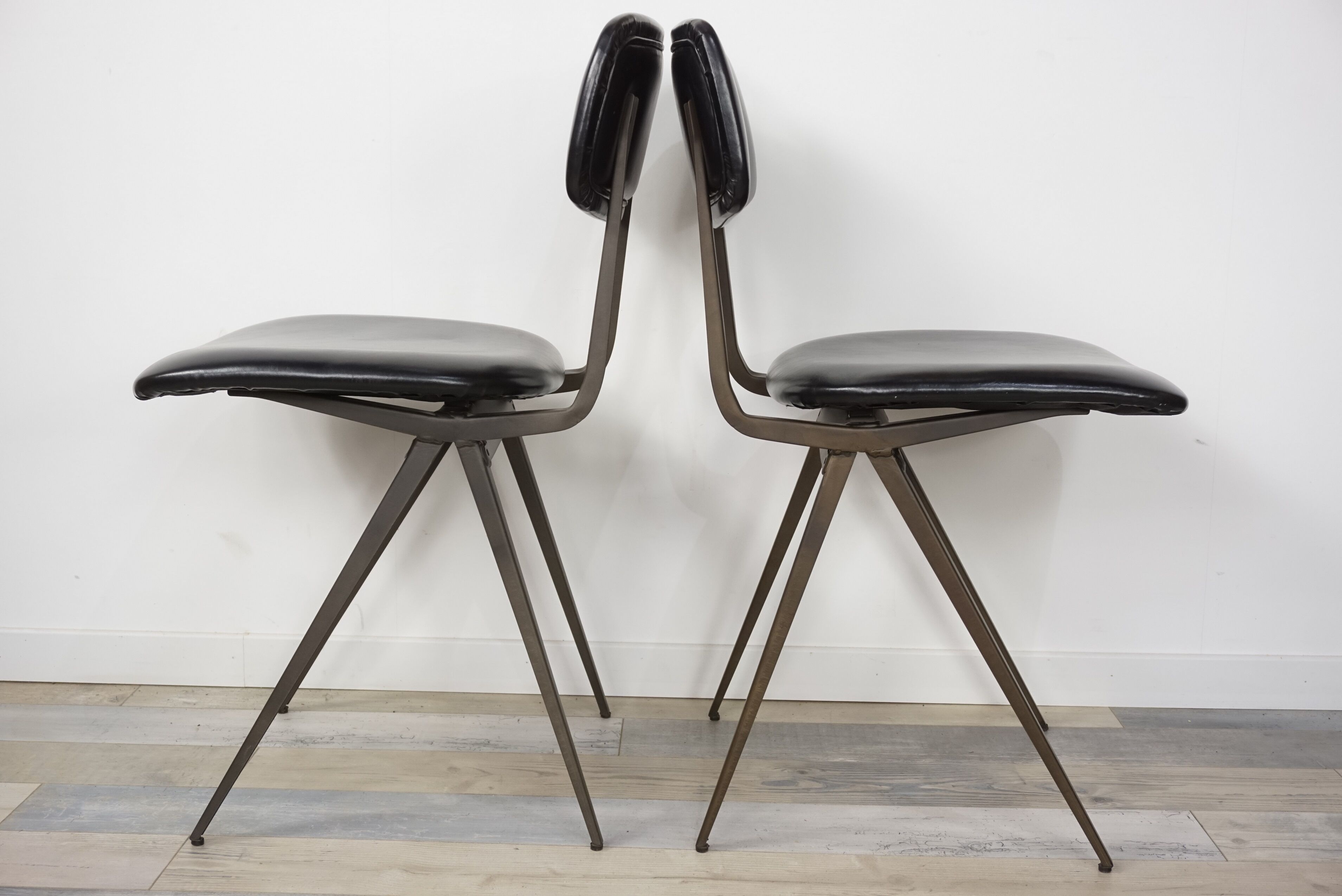 Pair of industrial style chairs in metal and faux black leather