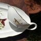 Large fish platter and its vintage porcelain sauce boat, decorated with pike.