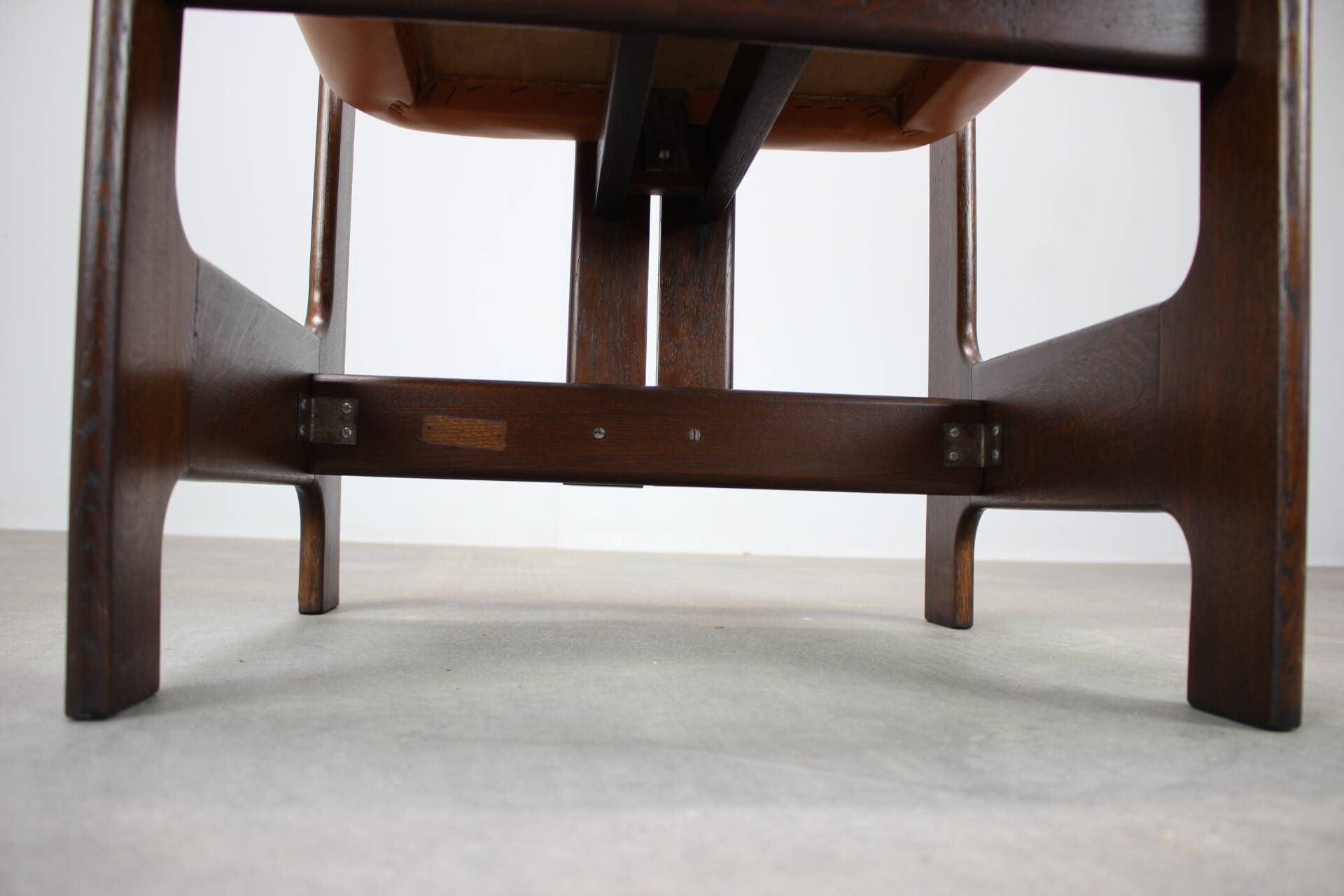 Vintage German sculptural chair from the 1970s in wood with orange faux leather.
