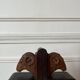 Pair of carved wooden bookends in the shape of ram's heads.
