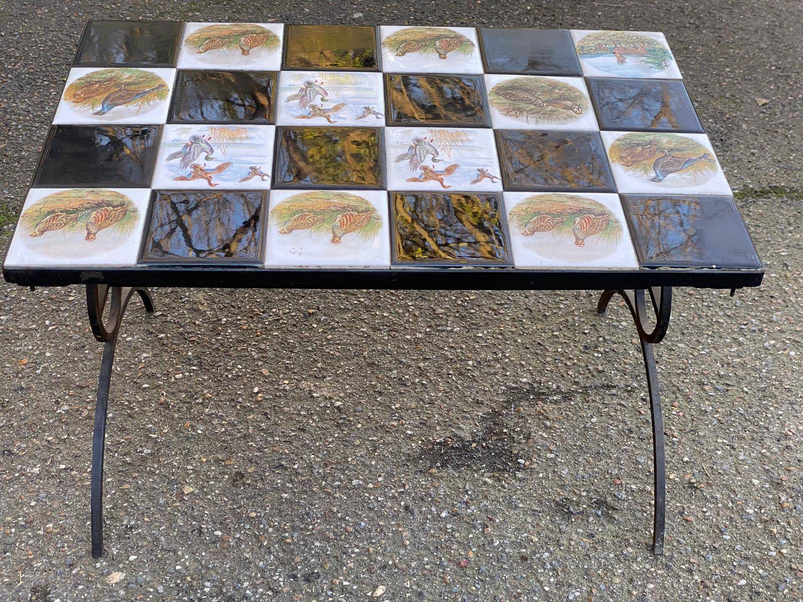 Vintage coffee table with black wrought iron and white tiles.