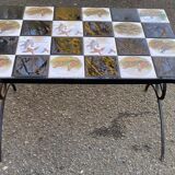 Vintage coffee table with black wrought iron and white tiles.
