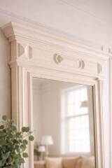Miroir ancien biseauté, cadre en bois et stuc patiné gris perle.