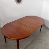 Round teak table with Scandinavian design extensions from the 60s vintage