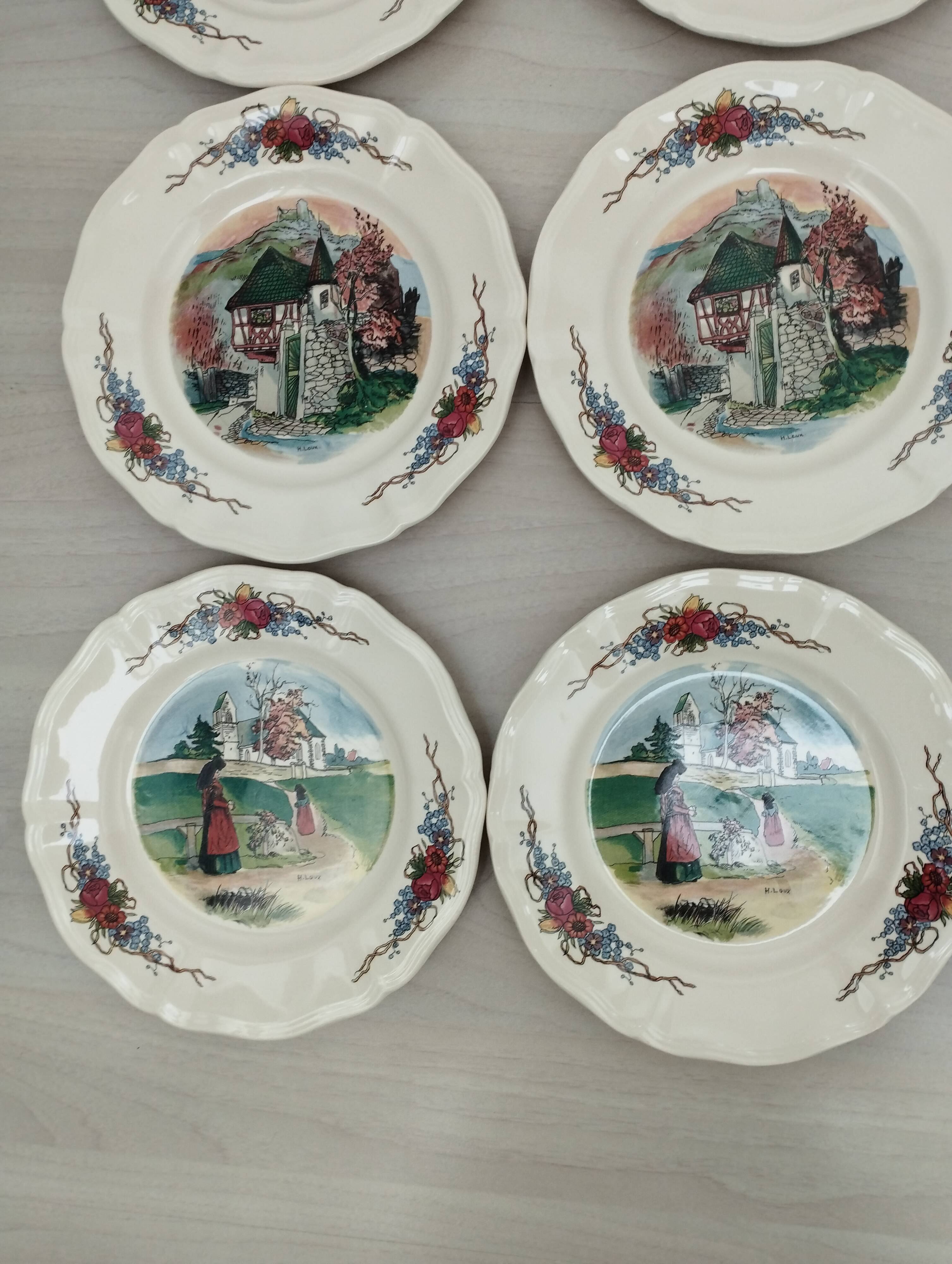 12 plates of the Obernai earthenware décor service signed Henri Loux