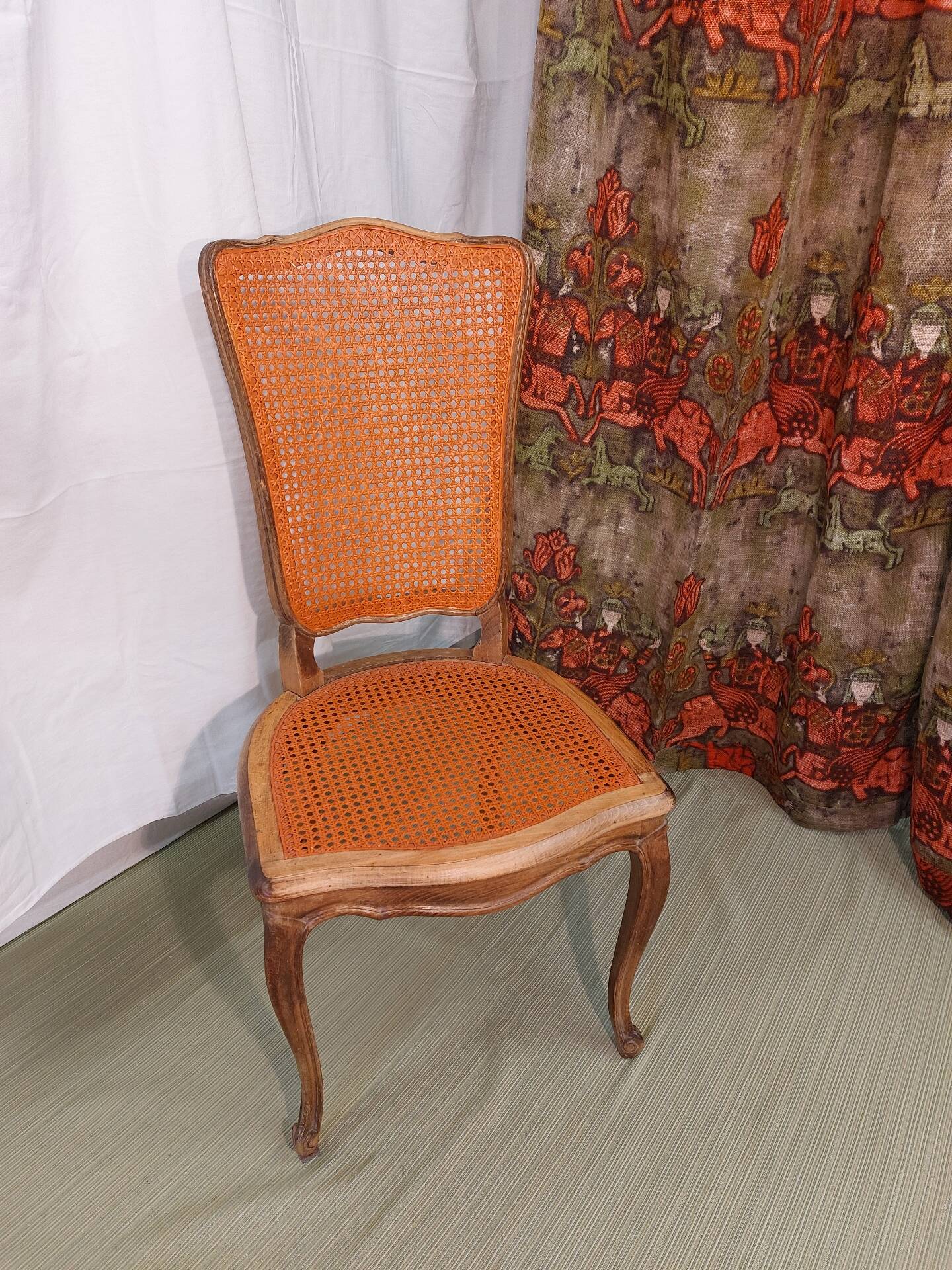 Caned chair in Louis XV style painted orange.