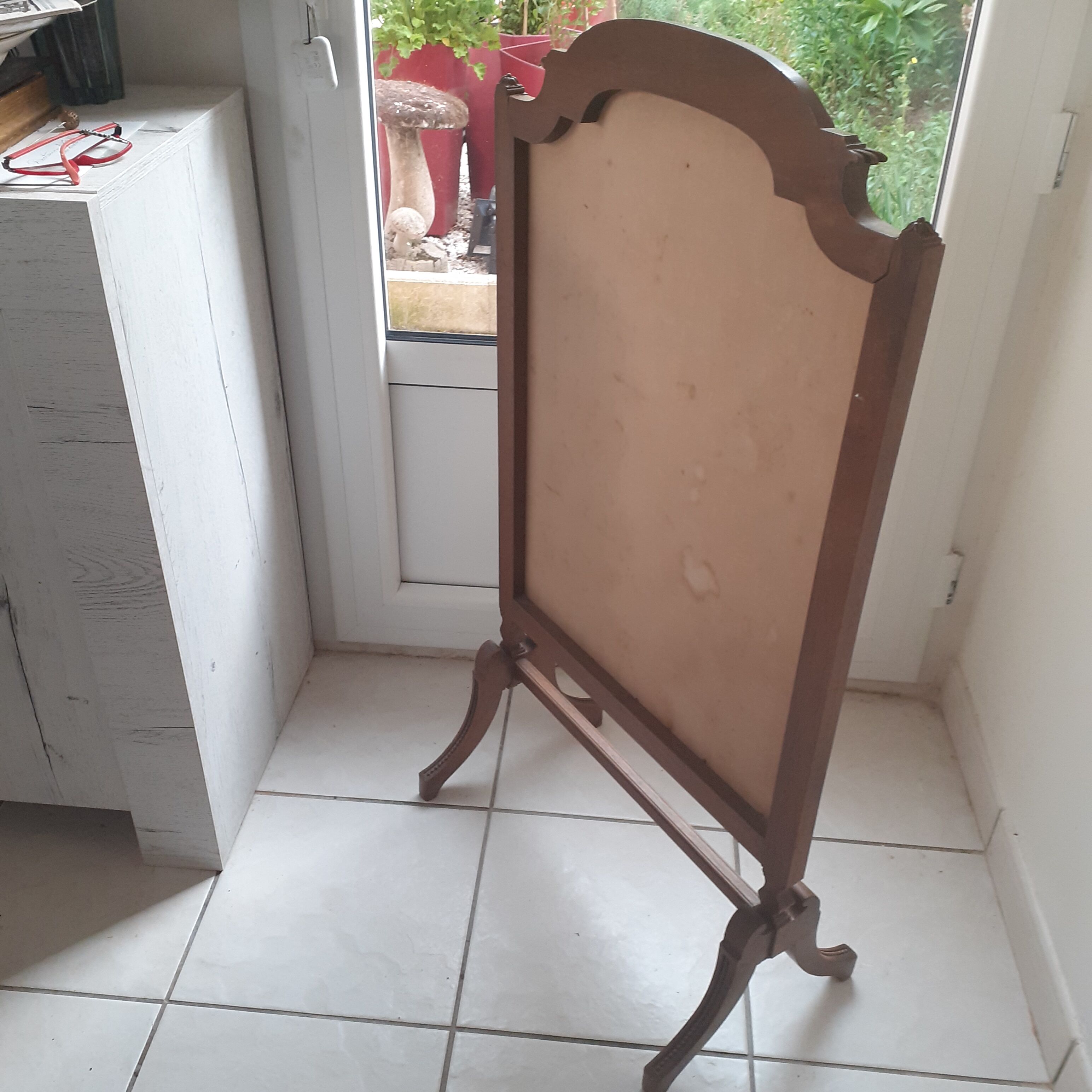 Antique fireplace screen made of wood and original fabric