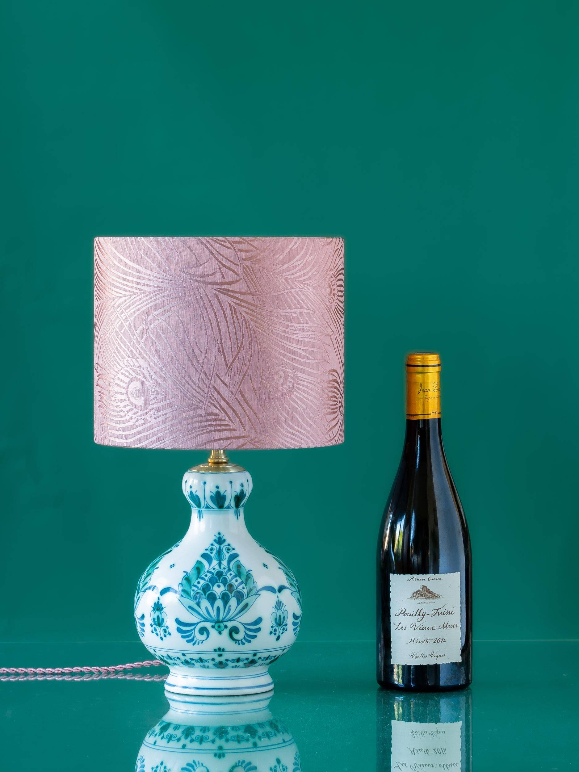 Royal Delft blue-green ceramic table lamp with pink jacquard peacock shade.