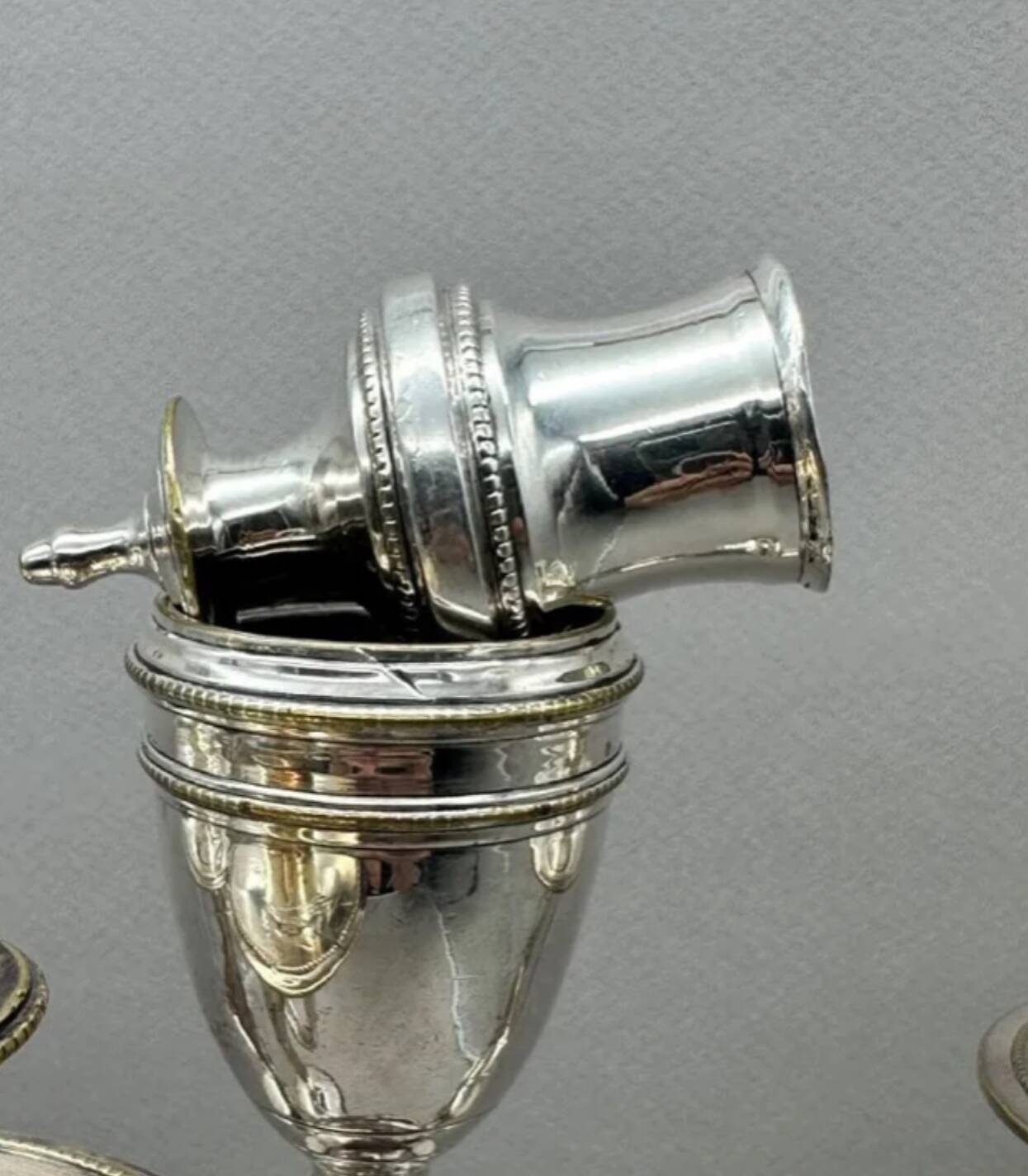 Pair of silver-plated metal candelabra decorated with hunting horns