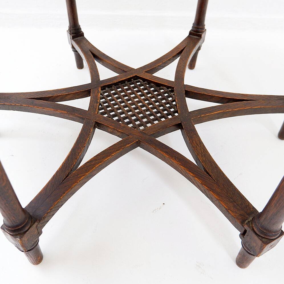 Hexagonal pedestal table or side table with a lattice structure and star pattern.
