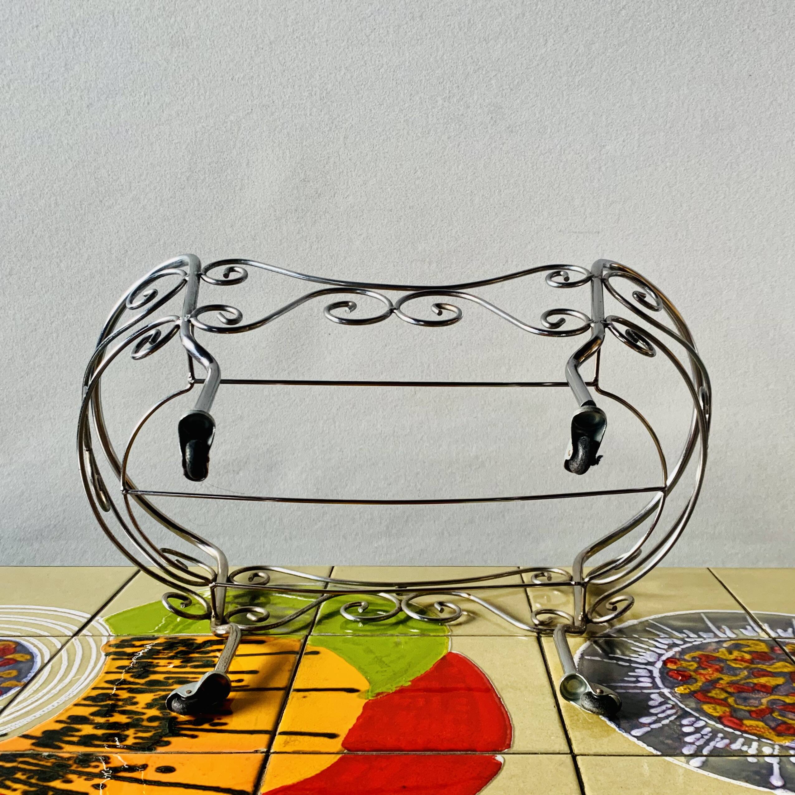 Metal doll's bed on vintage casters