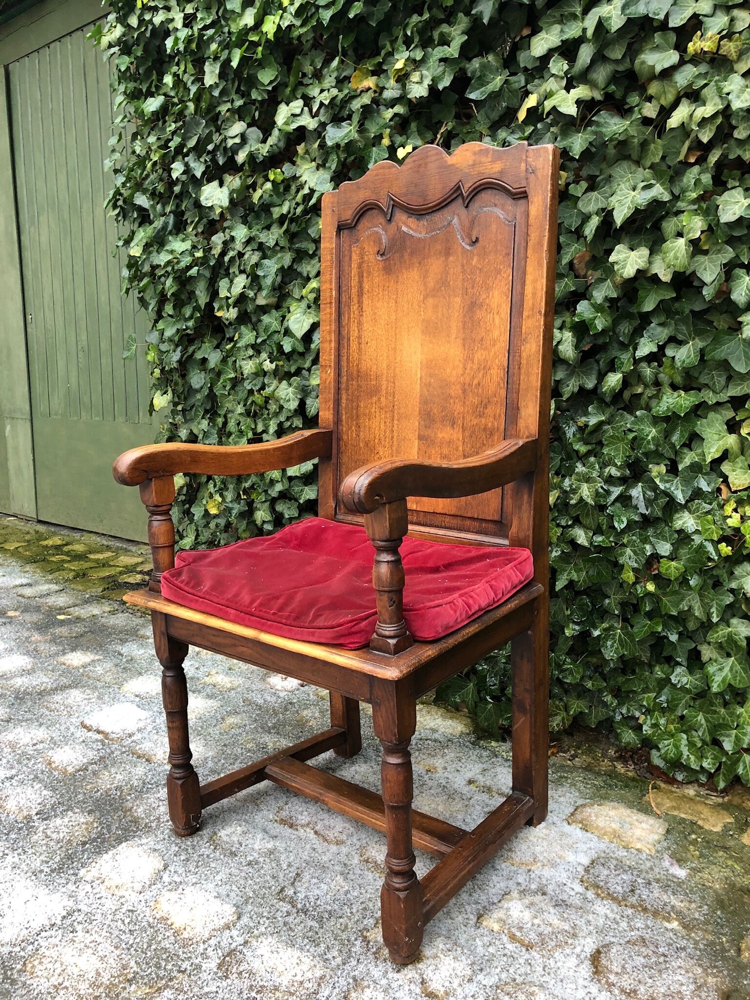 Wooden armchair with velvety red cushion