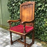Wooden armchair with velvety red cushion