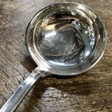 Small silver metal ladle from the Christofle brand, shell model