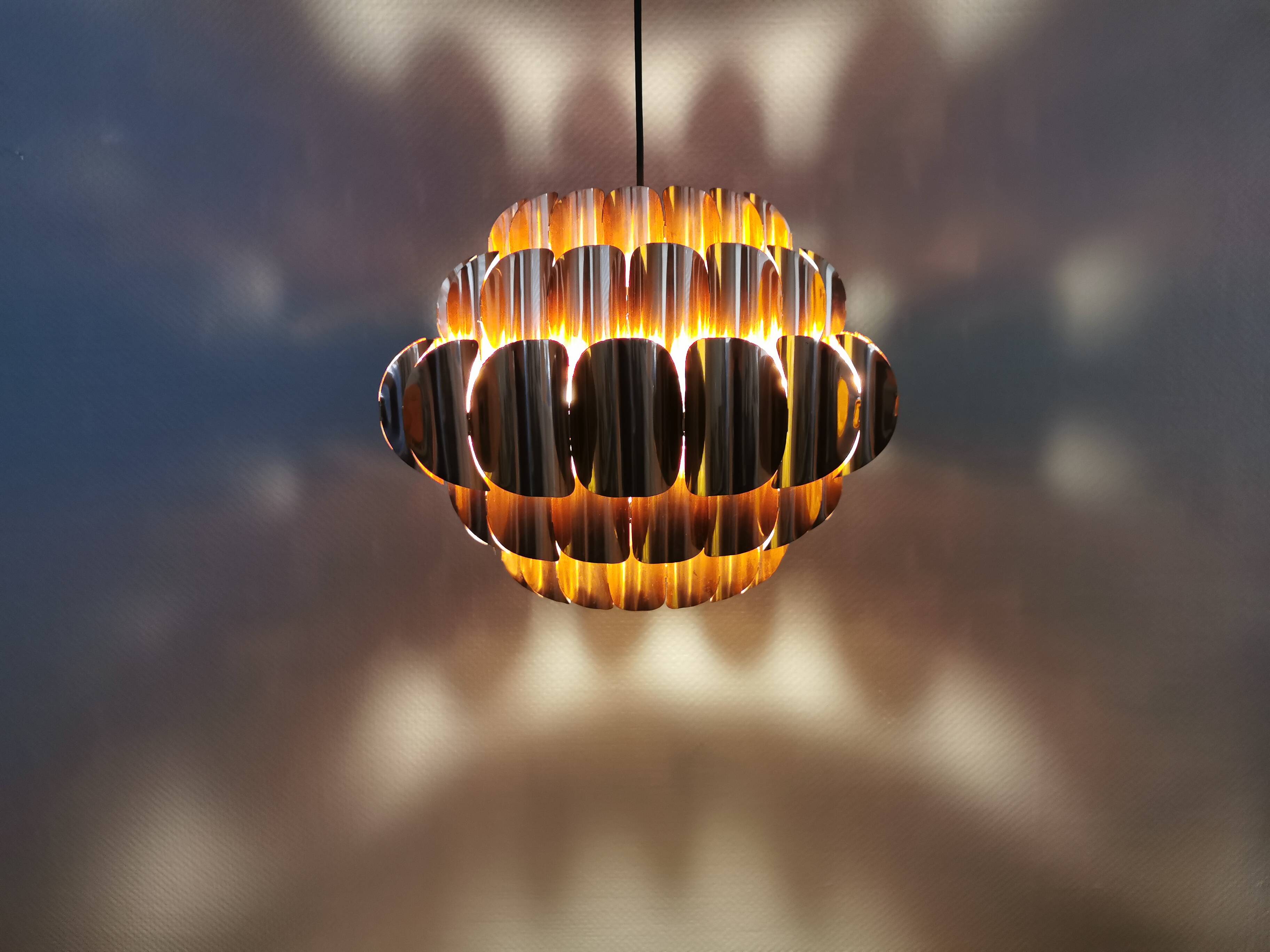 Copper colored hanging lamp. designed by thorsten orrling sweden