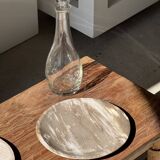 Tray, circular dish or plate made of white striped grey petrified wood.